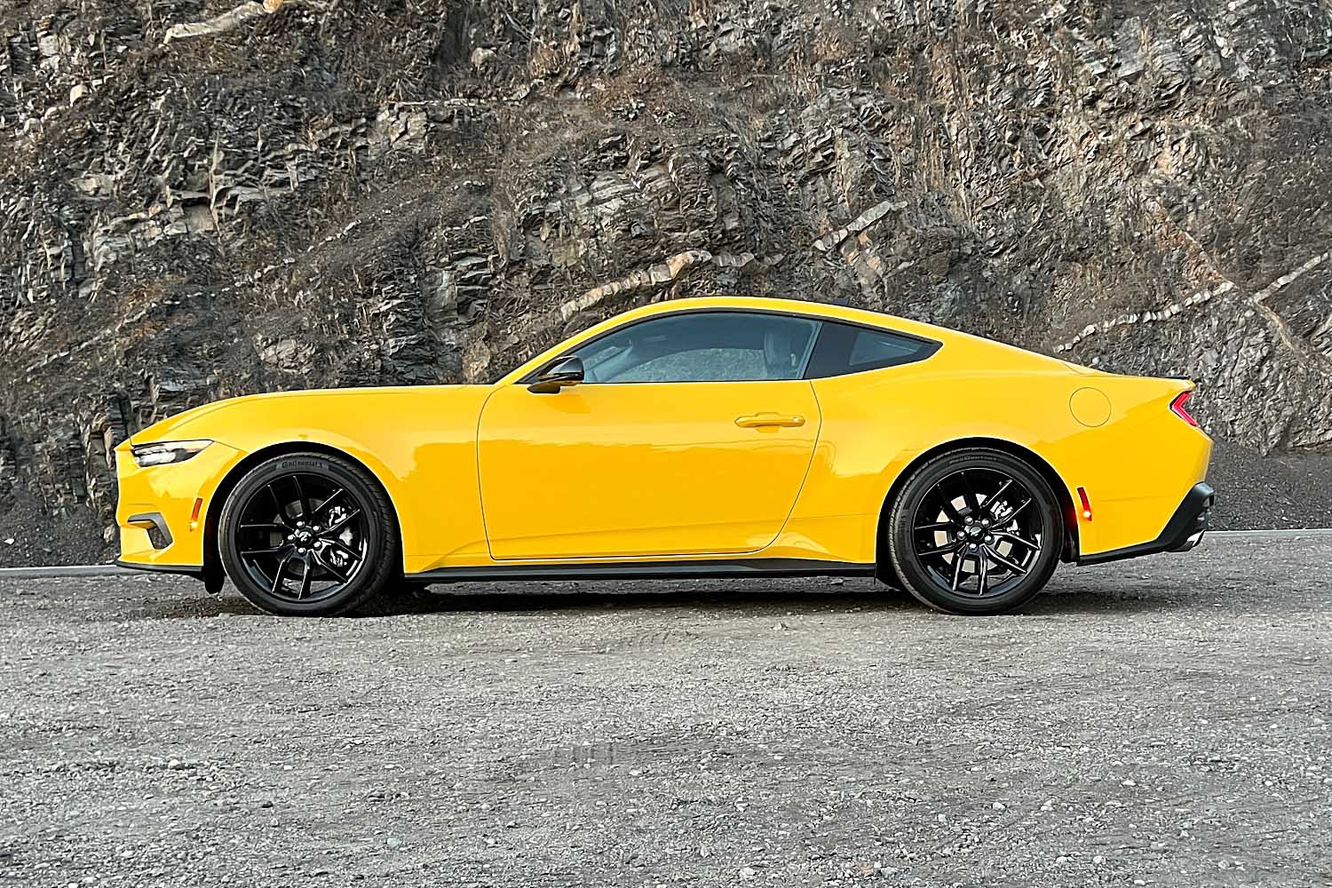 2024 Ford Mustang in Yellow Splash Metallic, side profile view.