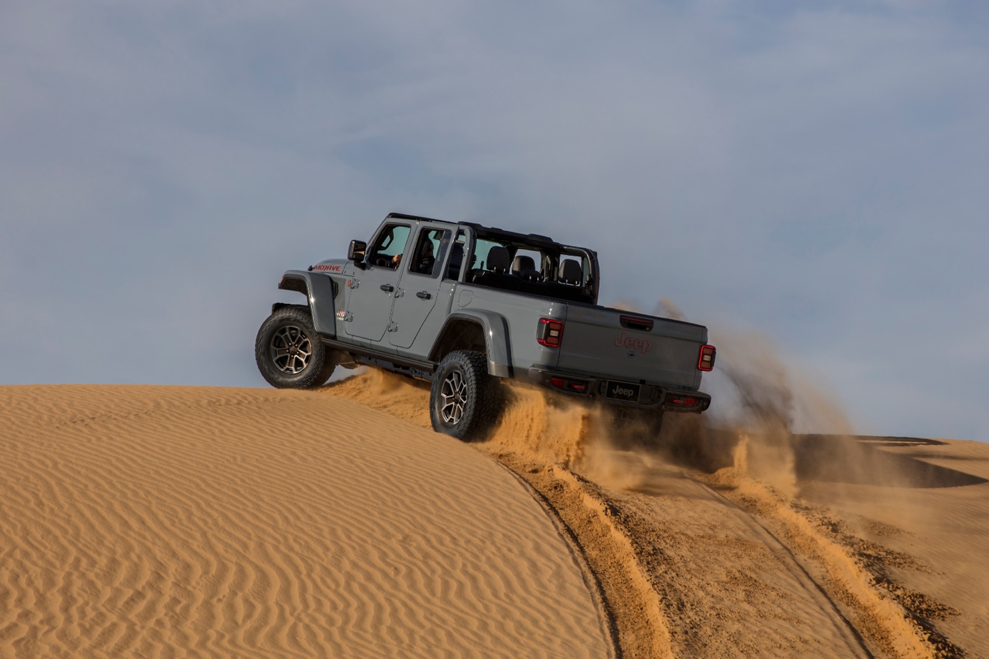 2024 Jeep Gladiator Mojave in gray driving across desert sand
