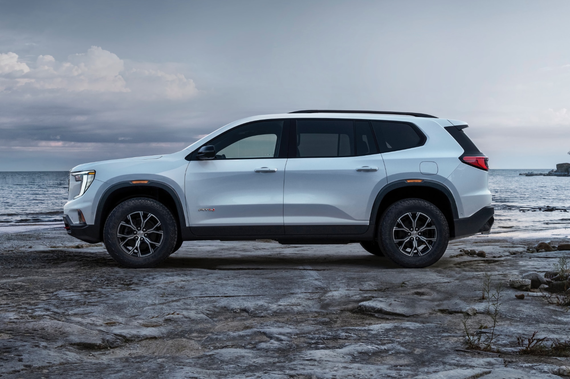 2024 GMC Acadia AT4 in white parked by the ocean