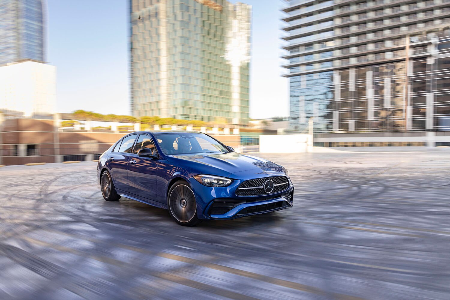 2022 Mercedes-Benz C-Class in blue driving on pavement