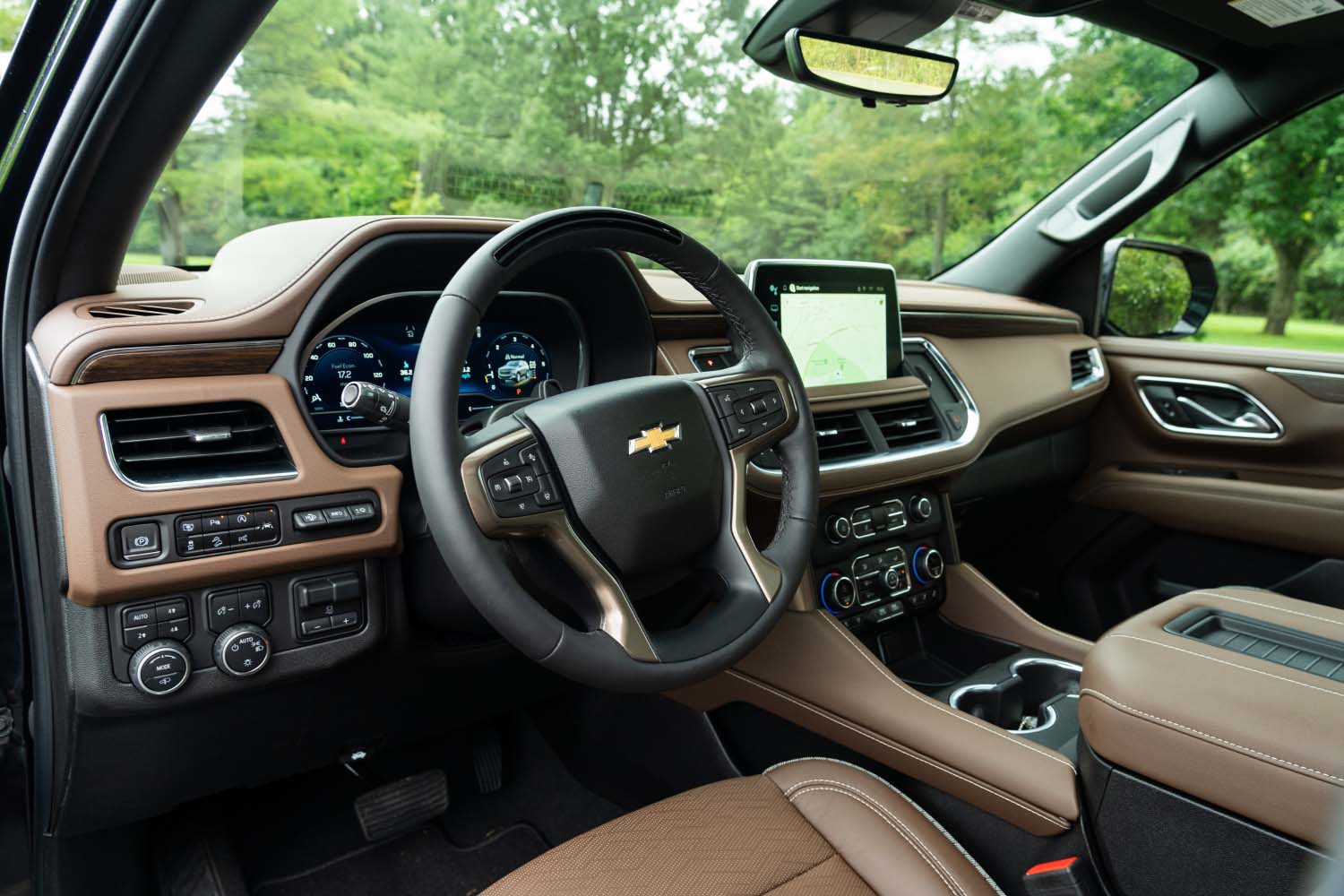 Steering wheel and cockpit of 2023 Chevrolet Suburban in tan upholstery 