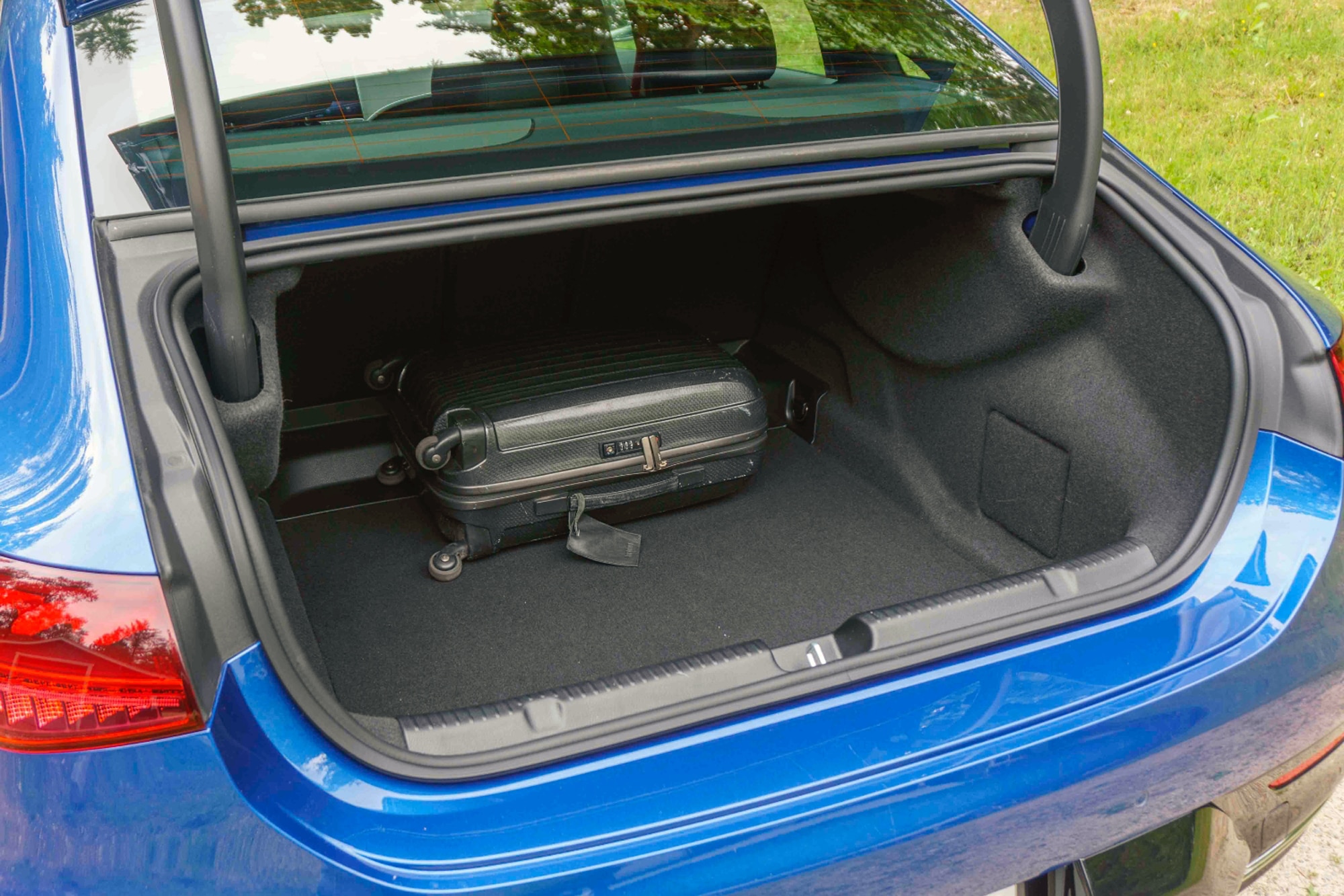 2023 Mercedes-Benz EQE Sedan in Starling Blue open cargo area with black luggage inside