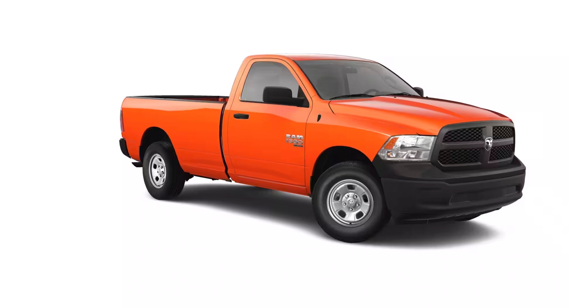 Front right quarter shot of orange 2023 Ram 1500 Classic on a white background