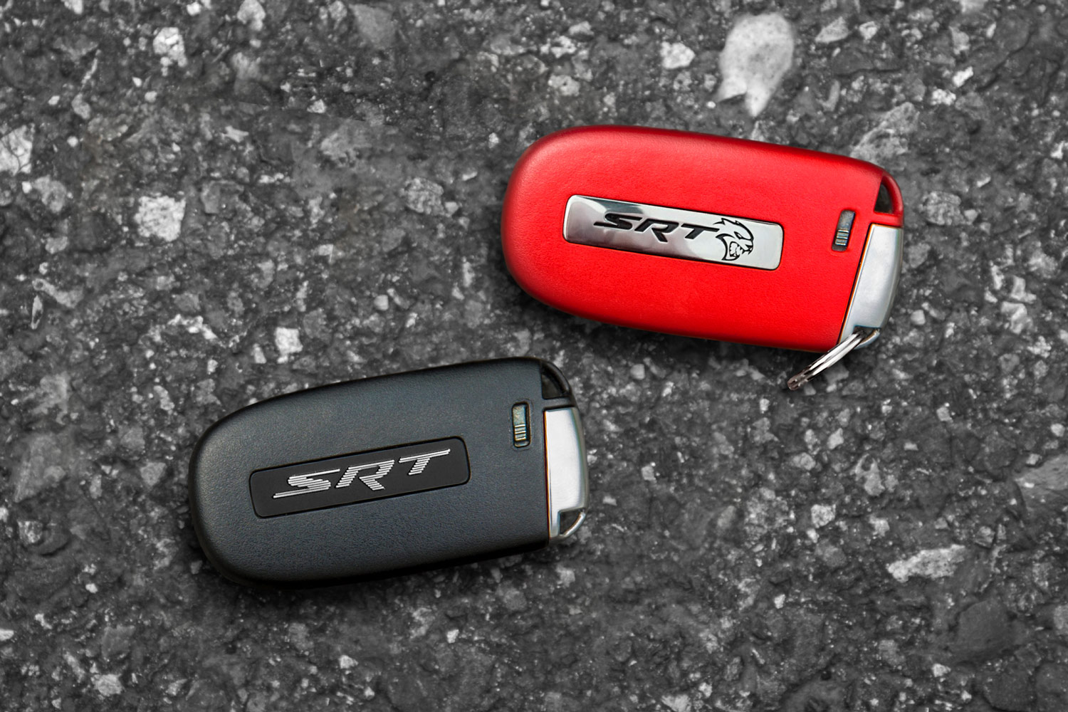 a red and a black Dodge key fob