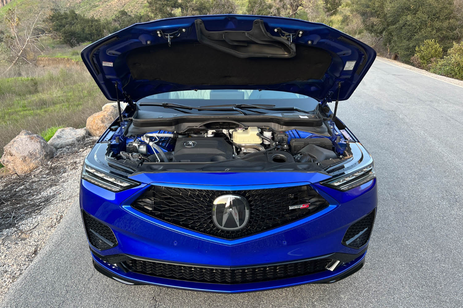 2023 Acura MDX Type S in Apex Blue Pearl with the hood up displaying the engine bay and the turbocharged 3.0-liter V6.