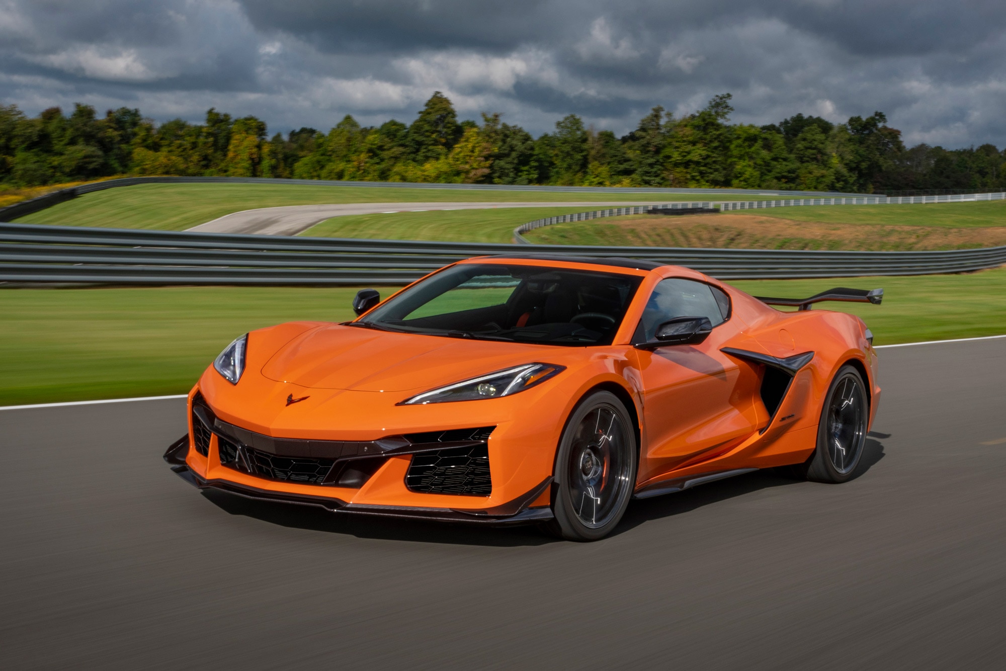 Orange 2024 Chevrolet Corvette Z06 driving on racetrack.