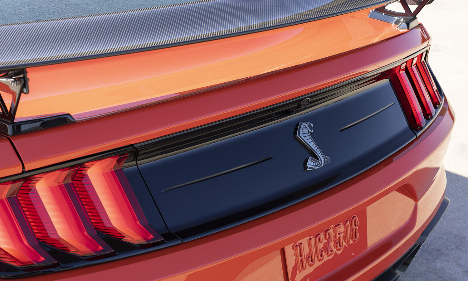 Rear end of an orange 2022 Ford Mustang Shelby GT500