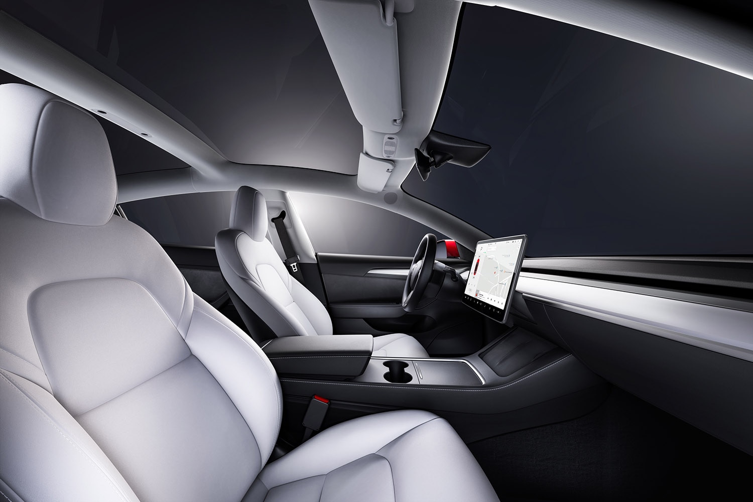 Interior of Tesla Model 3 with seats and infotainment screen lit up