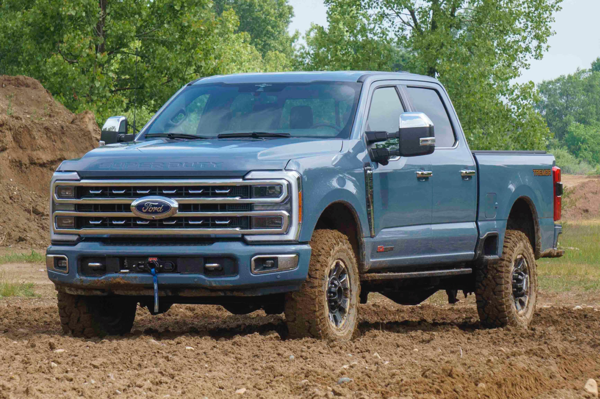 2023 Ford F-250 Super Duty Tremor in blue front quarter parked in the dirt