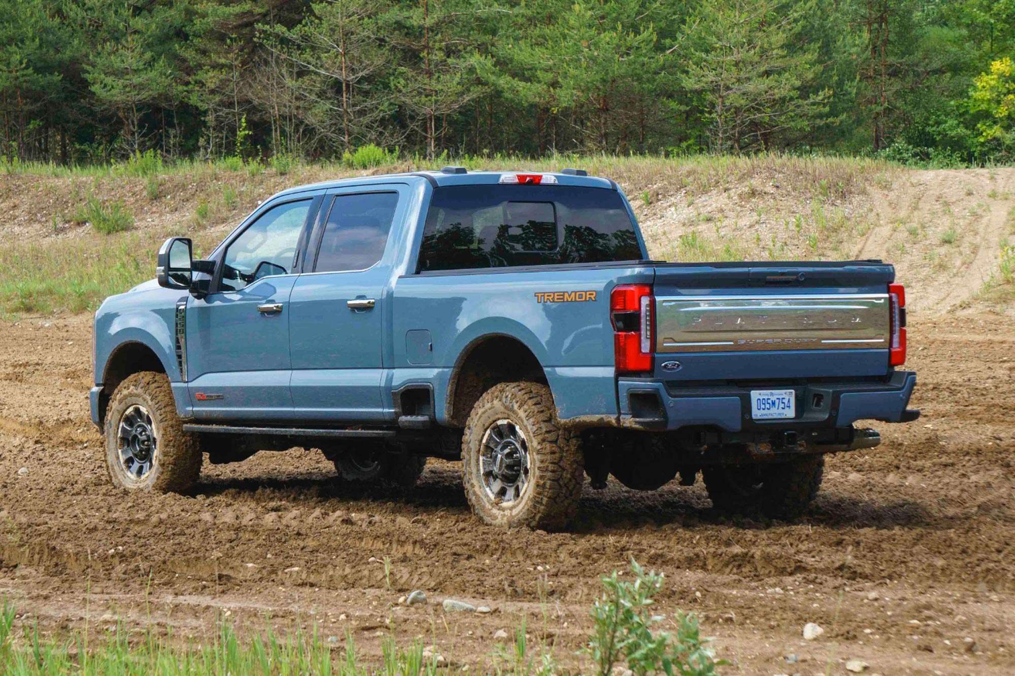 2023 Ford F-250 Super Duty Tremor in blue rear quarter parked in the dirt