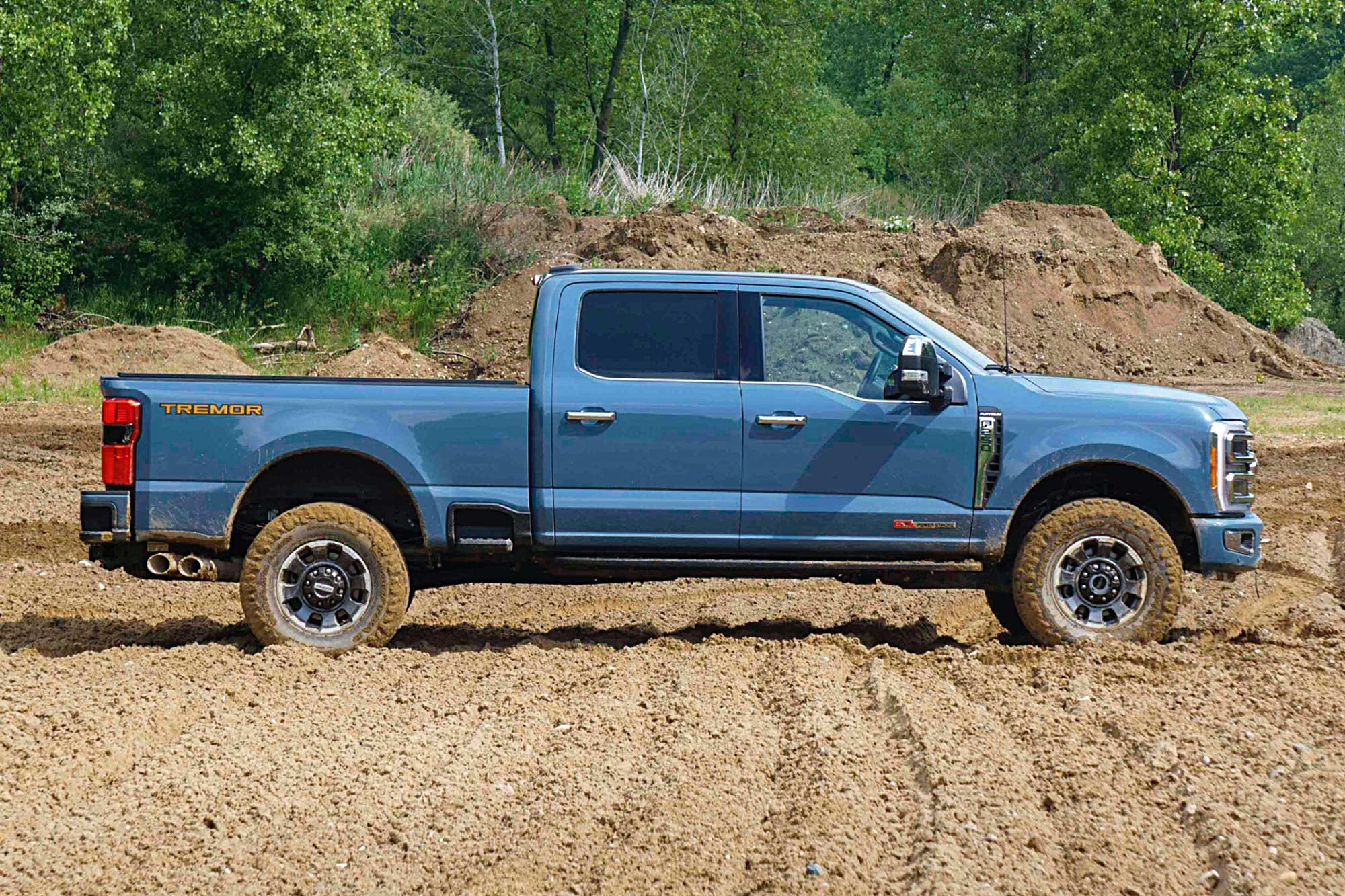2023 Ford F-250 Super Duty Tremor in blue side view parked in the dirt