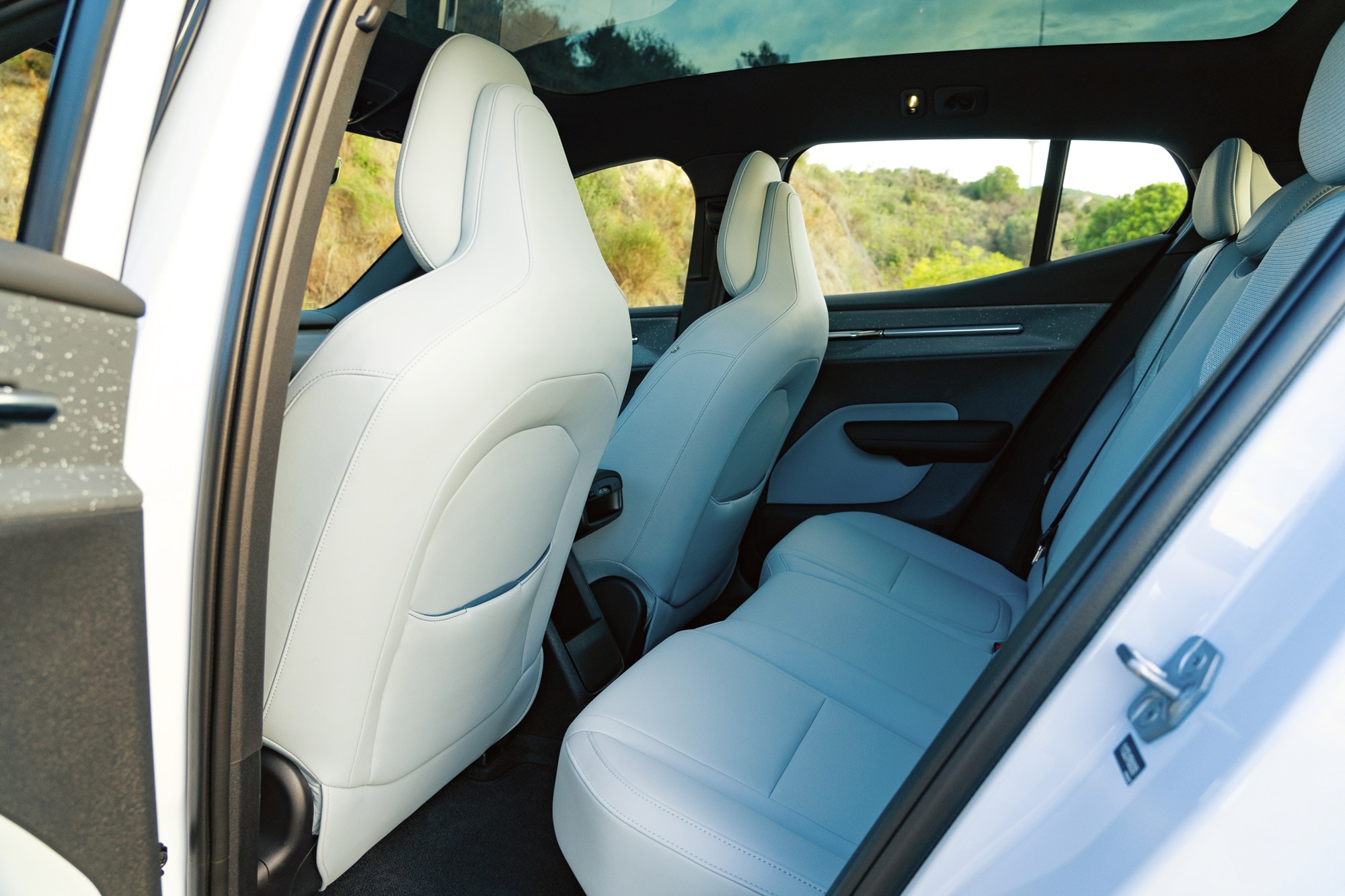 2025 Volvo EX30 rear seat with white artificial leather interior.
