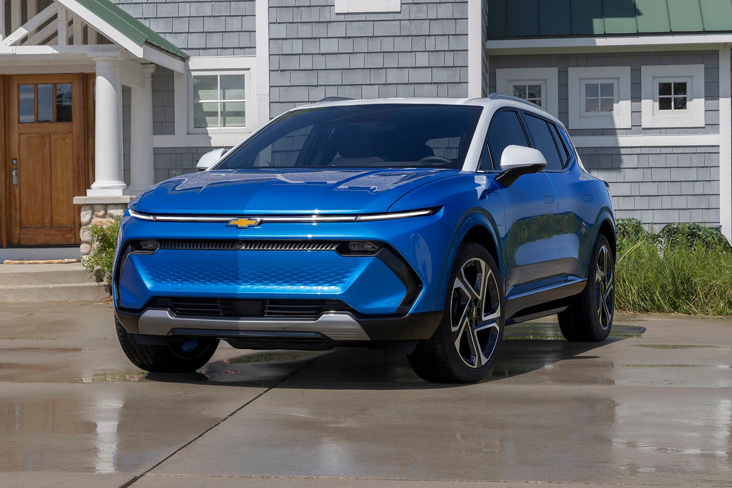 Blue 2024 Chevrolet Equinox EV parked in front of house