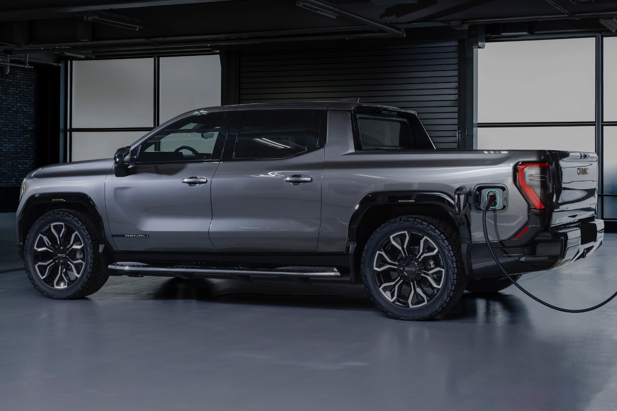 2024 GMC Sierra EV Denali 1 Edition in gray plugged in