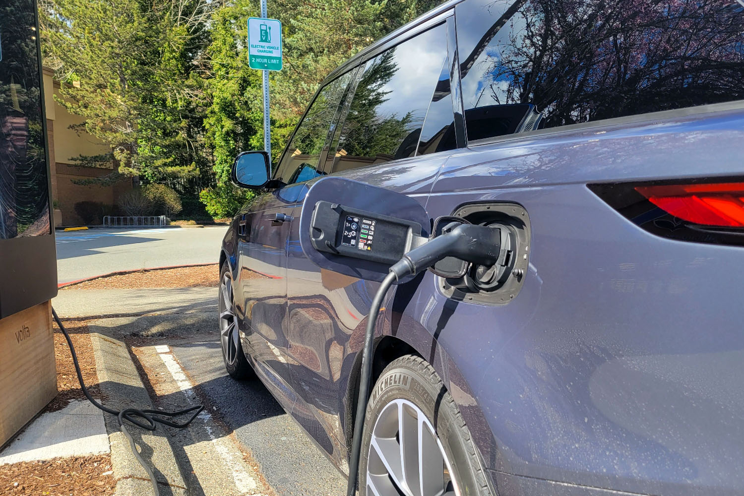 2023 Land Rover Range Rover Sport PHEV plugged in at a Volta public charging station.