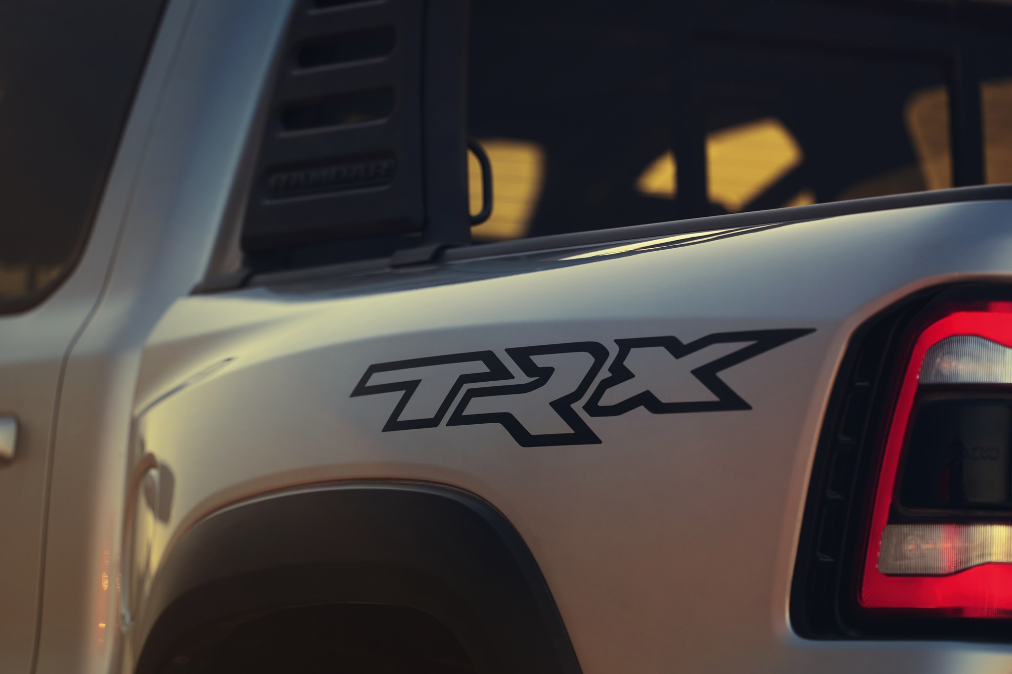 Close-up of the logo on a silver 2023 Ram 1500 TRX