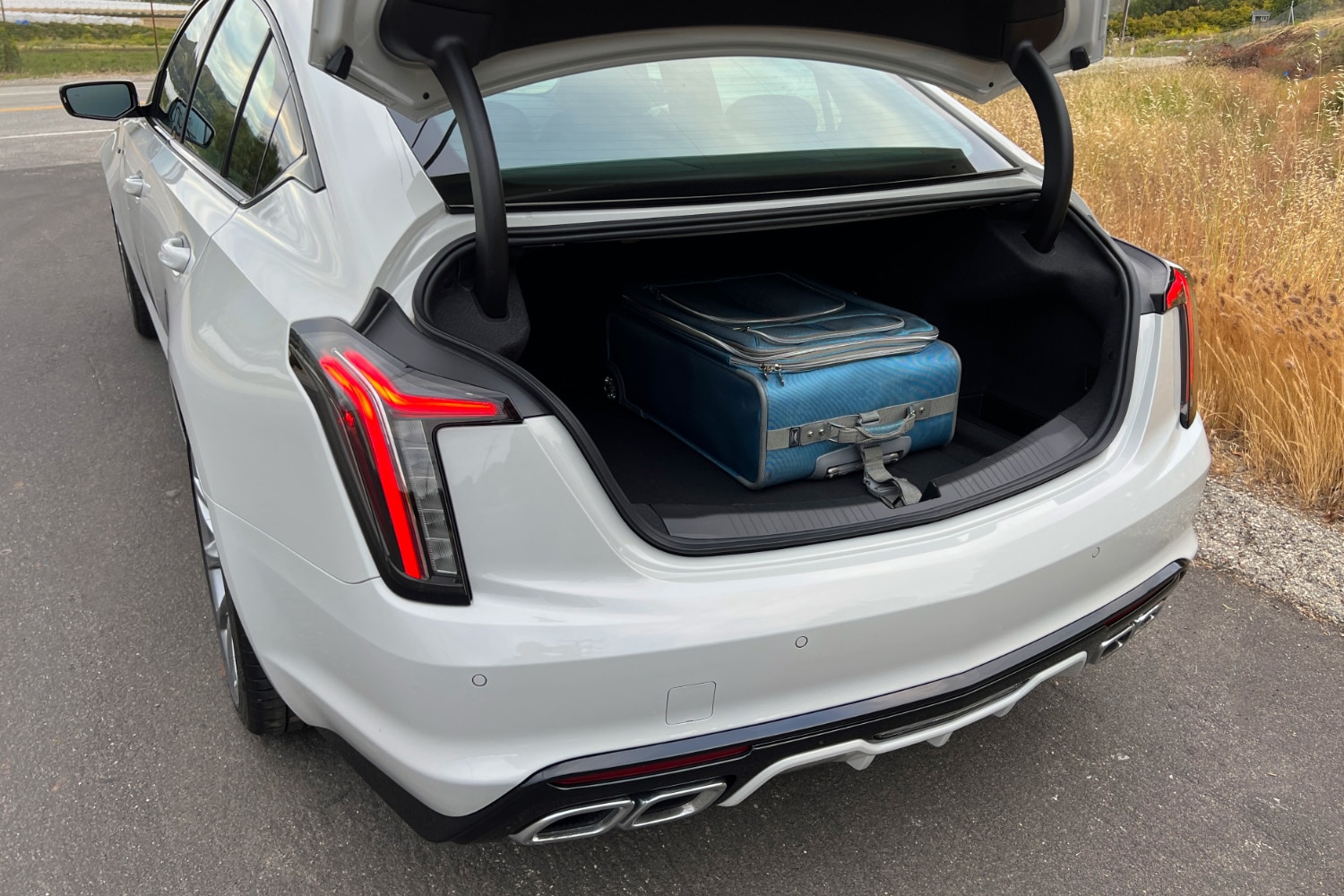 The truck of the 2023 Cadillac CT5-V with a large blue suitcase inside