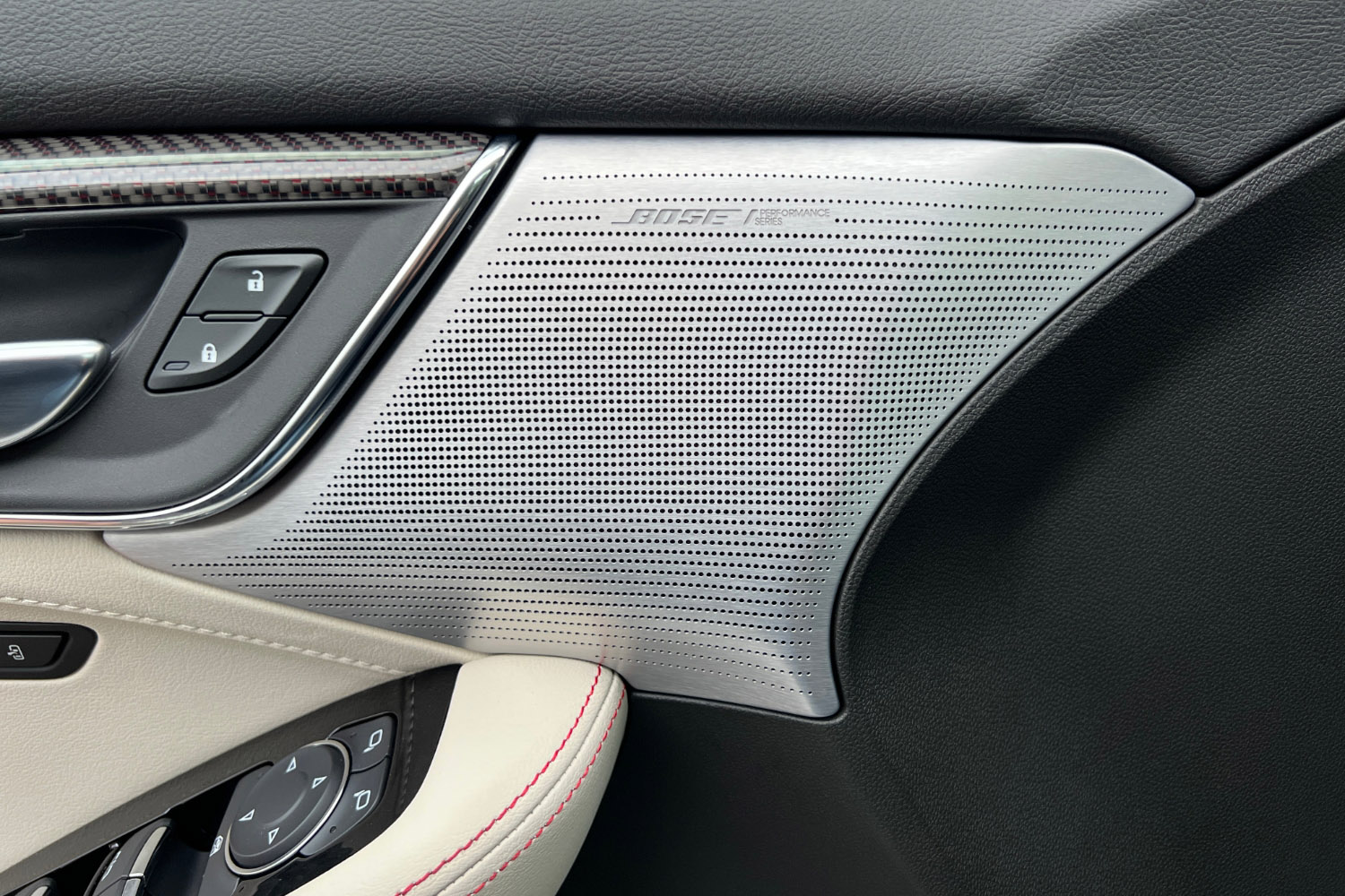 Detail shot of a metal Bose speaker grille on the door panel of a 2023 Cadillac CT5-V