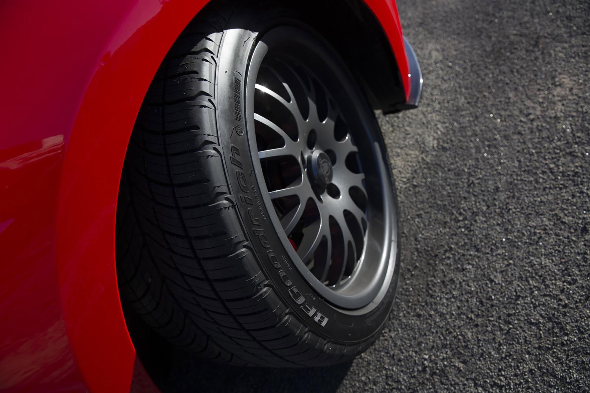 Detail shot of BFGoodrich g-Force COMP-2 all-season tire on a red Ford Mustang