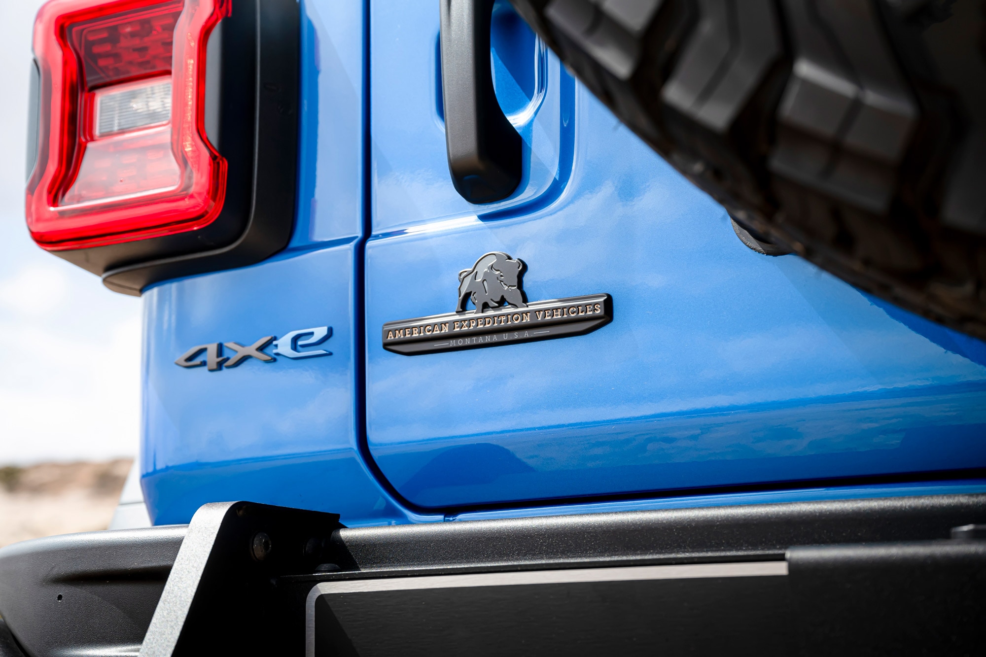 Close-up of an AEV badge on a blue Jeep Wrangler 4Xe
