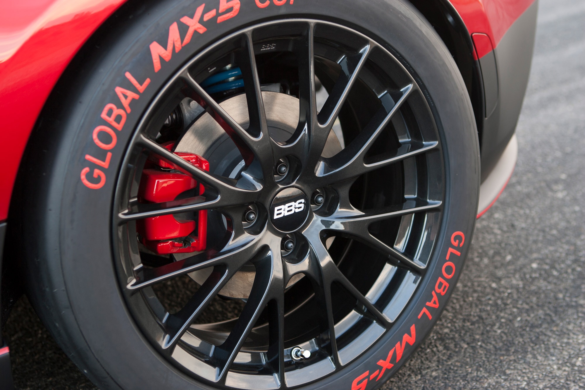 Close-up of a BBS wheel on a red Mazda MX-5 Miata Cup Car