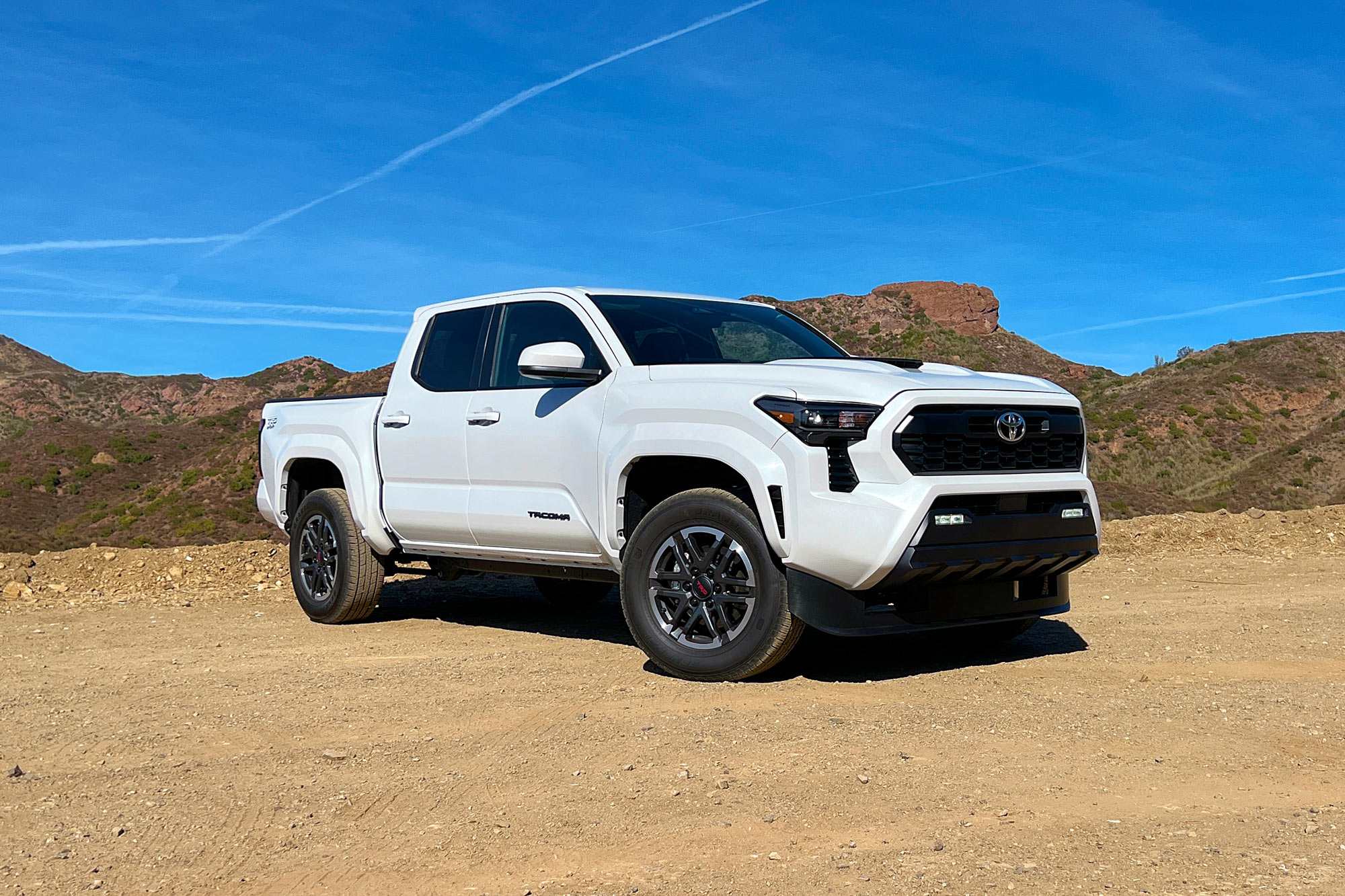 White 2024 Toyota Tacoma TRD Sport parked in the mountains