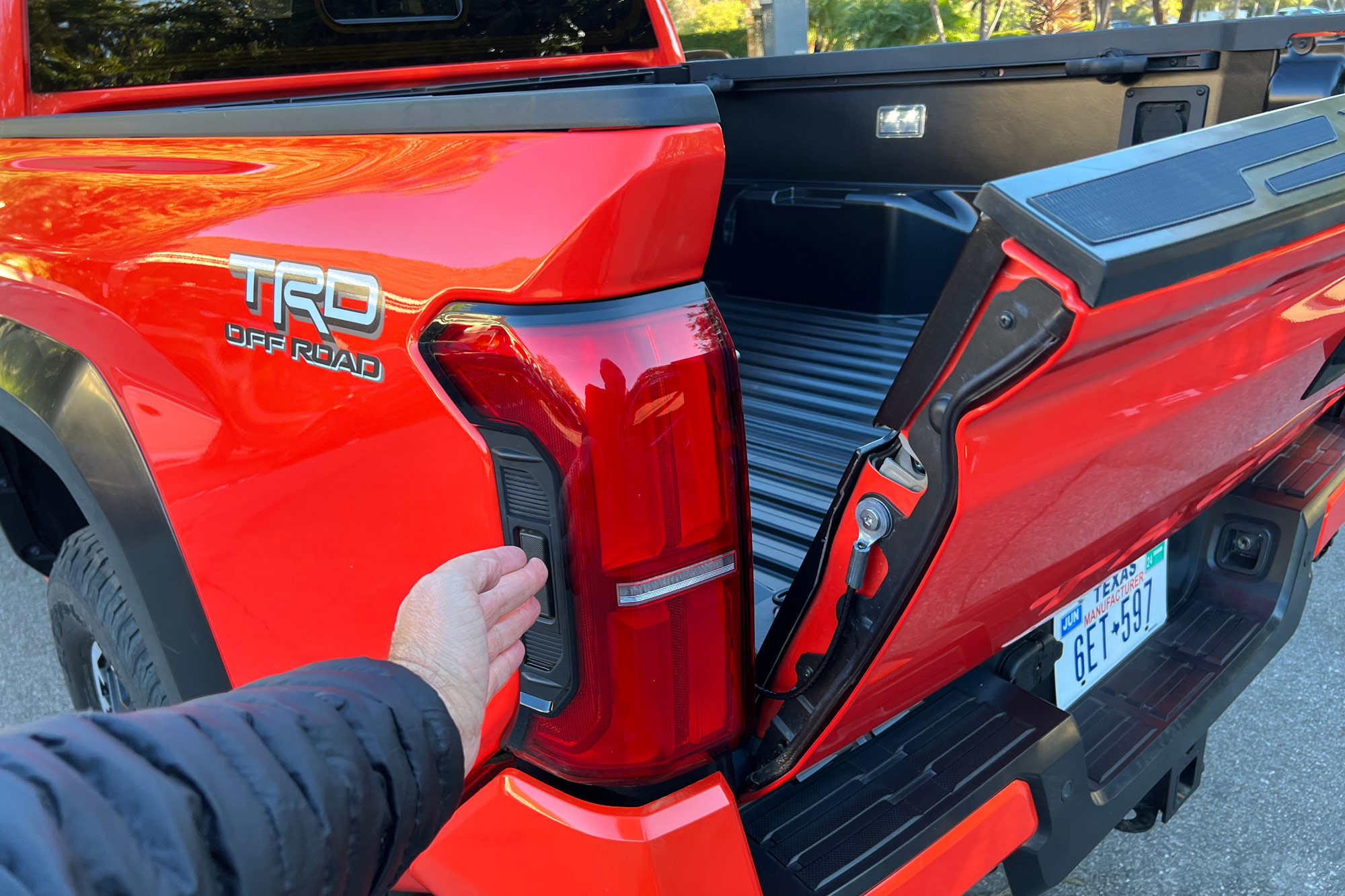 Orange 2024 Toyota Tacoma Off-Road power tailgate
