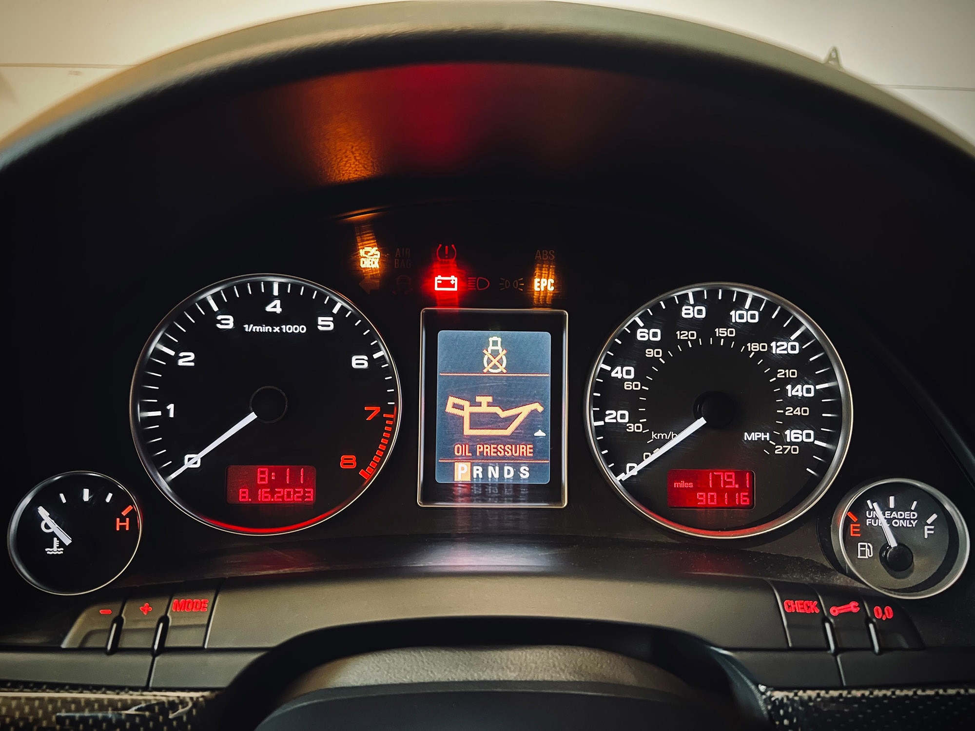 Instrument cluster displaying a check engine light while showing other warning lights.