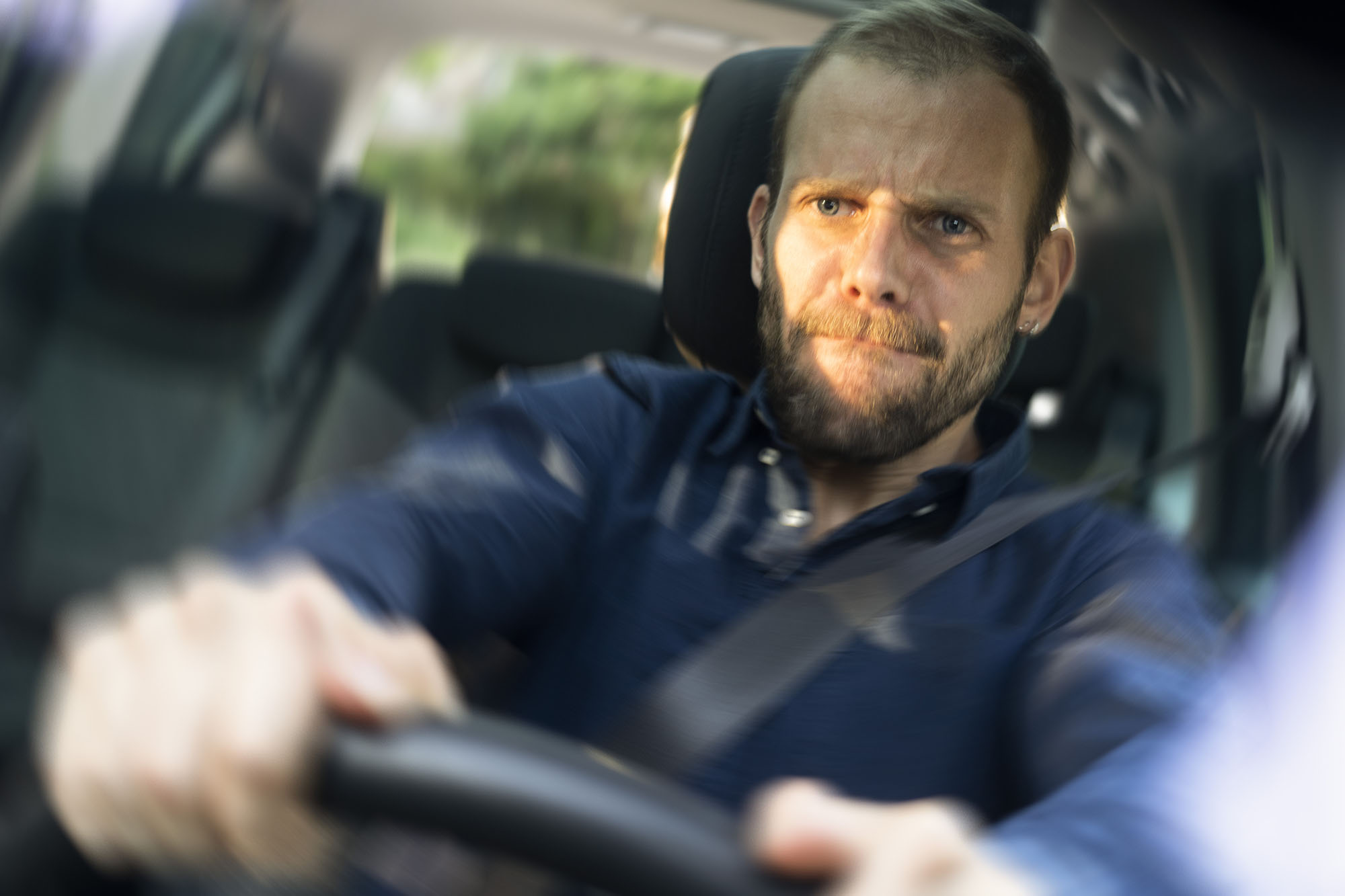 Person driving car with blurred surroundings