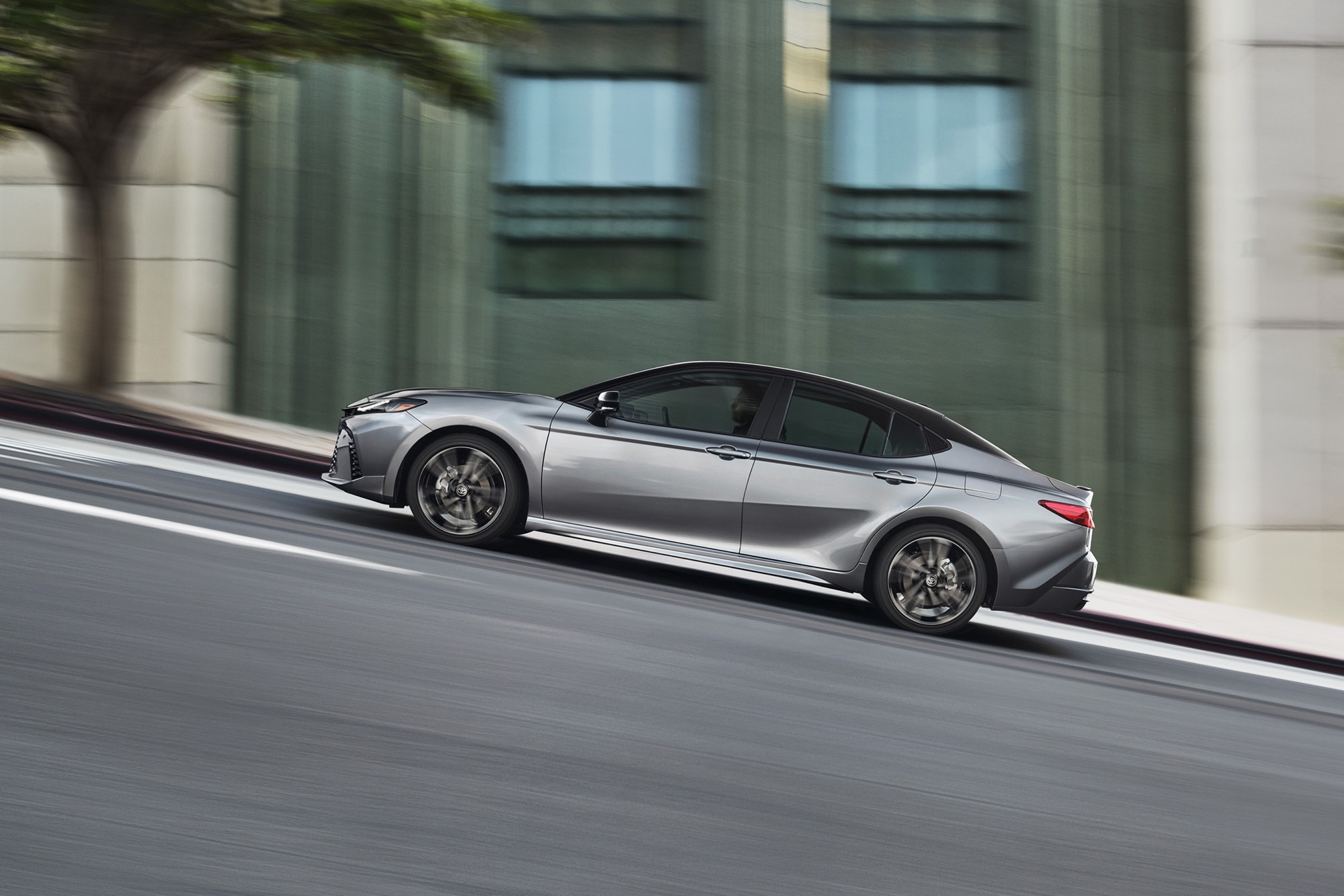 2025 Toyota Camry in gray, side profile driving view