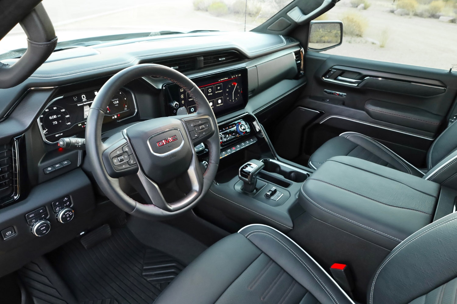 Interior view of the 2023 GMC Sierra 1500 AT4X showing the front seats and dash