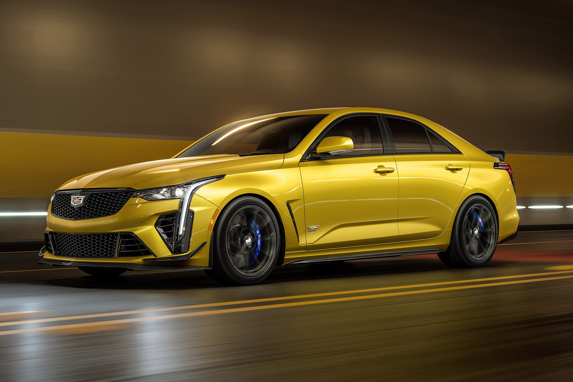 A yellow 2024 Cadillac CT4-V Blackwing driving in a tunnel
