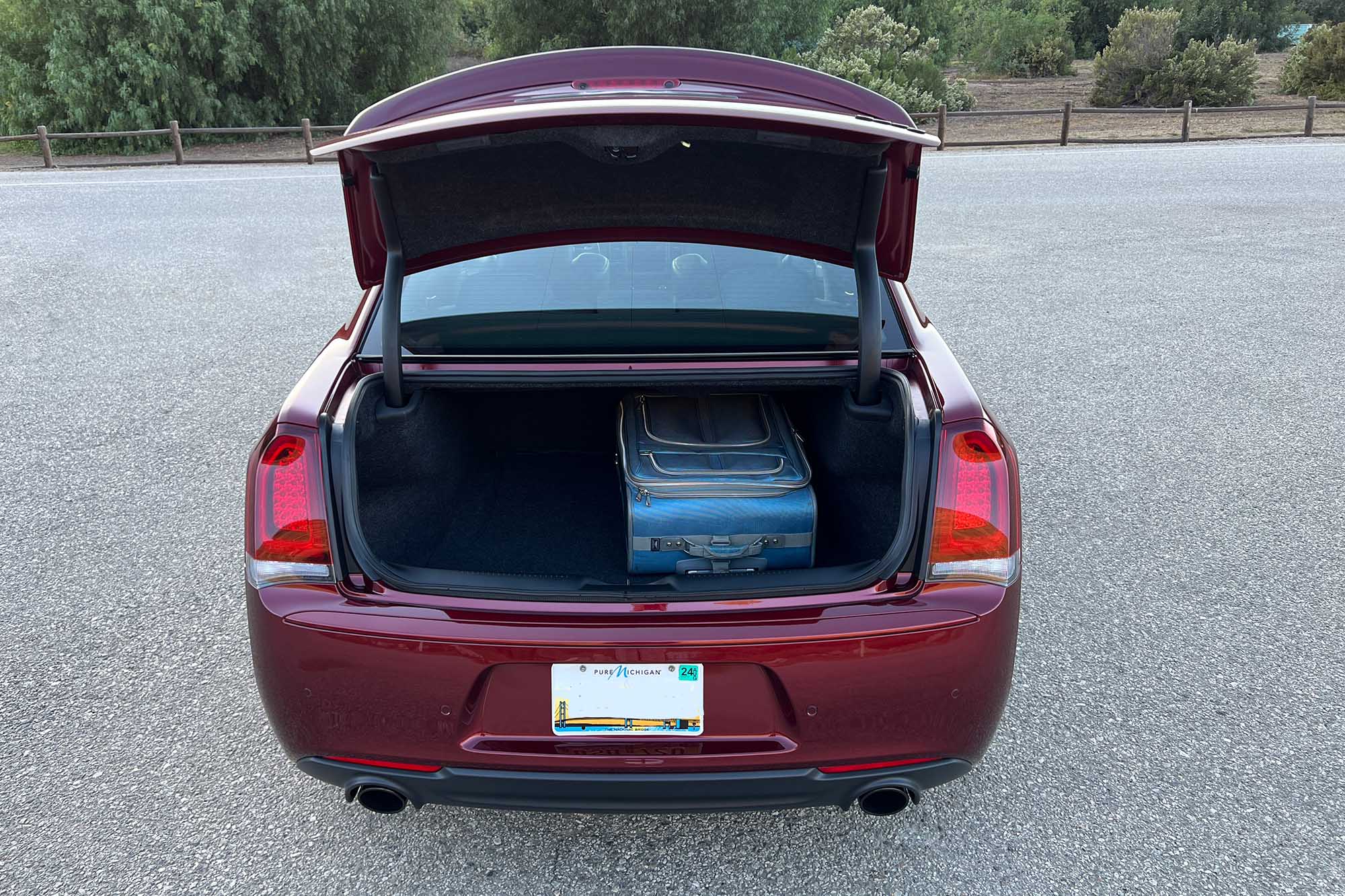 Truck of a 2023 Chrysler 300 carrying a blue suitcase