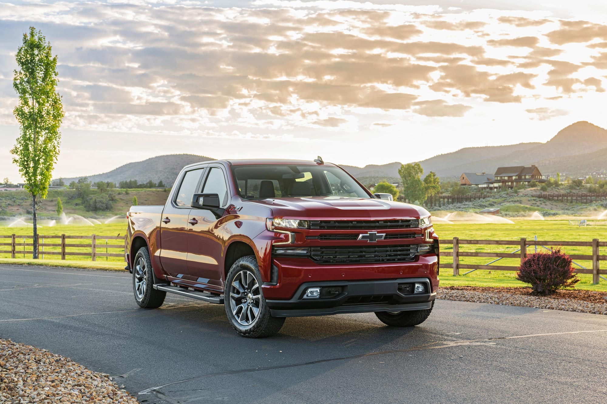 2023 Chevrolet Silverado parked on a road by a small field.
