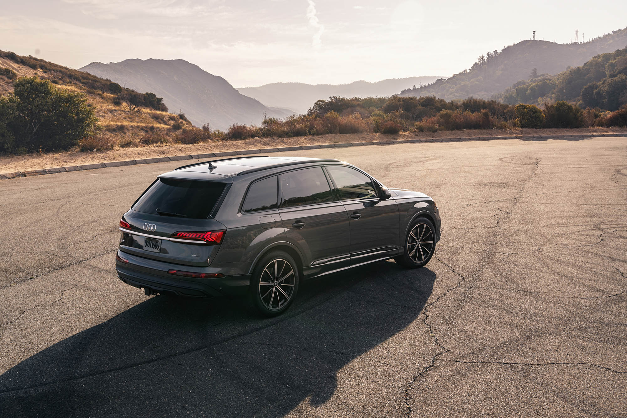 Audi Q7 in dark gray parked in the mountains.