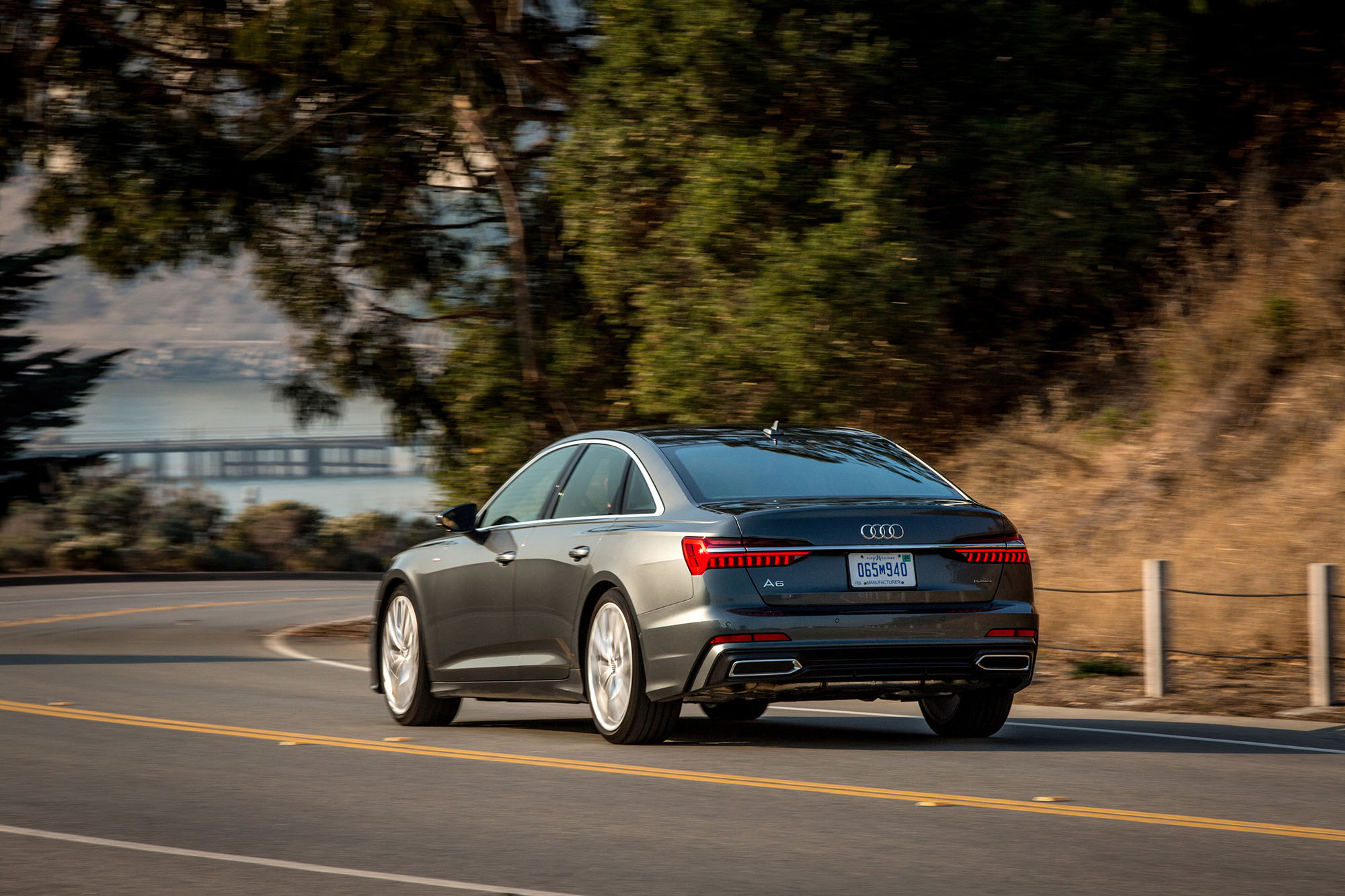 Rear view of a gray Audi A6 driving.