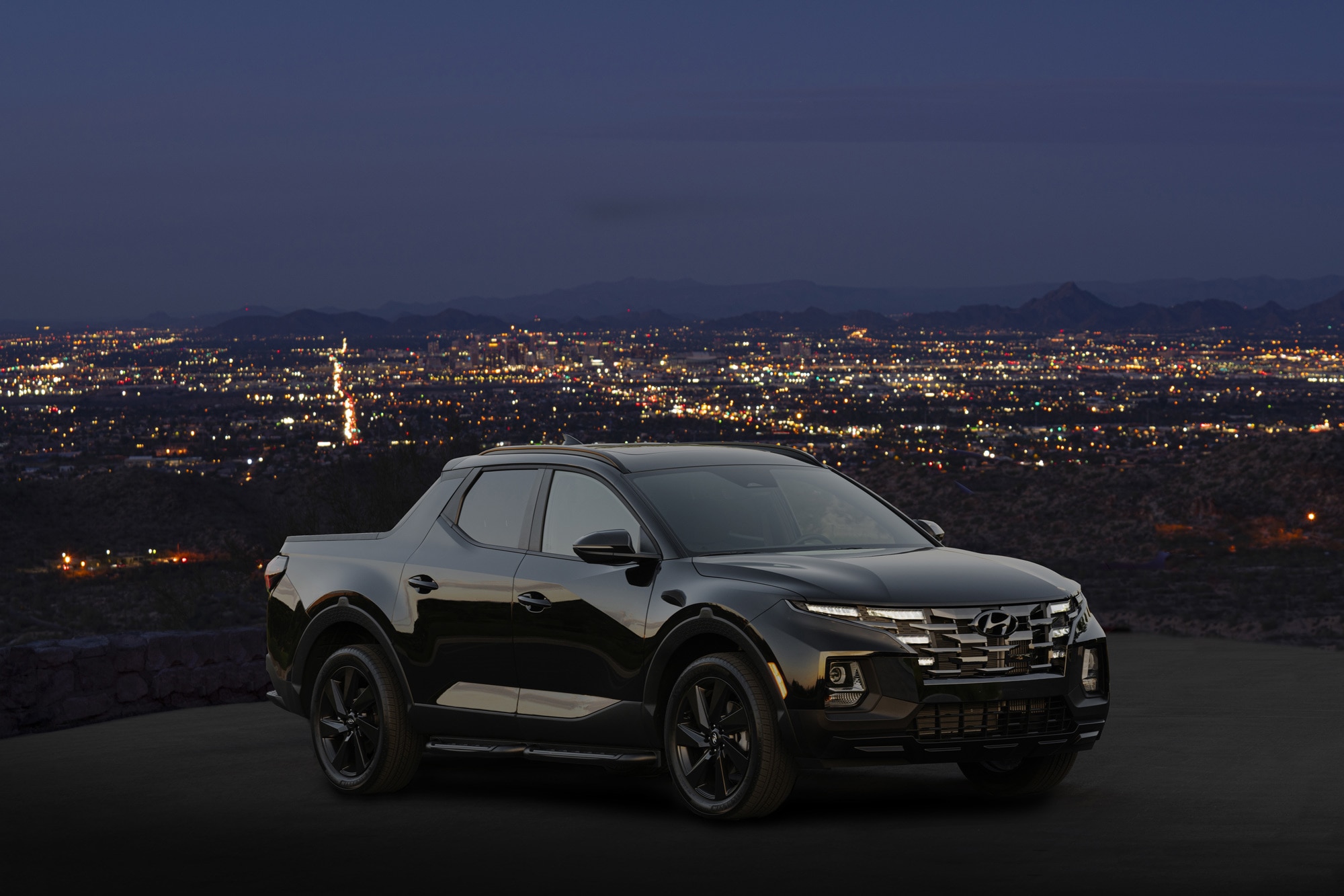  2023 Hyundai Santa Cruz parked at night time overlooking city lights