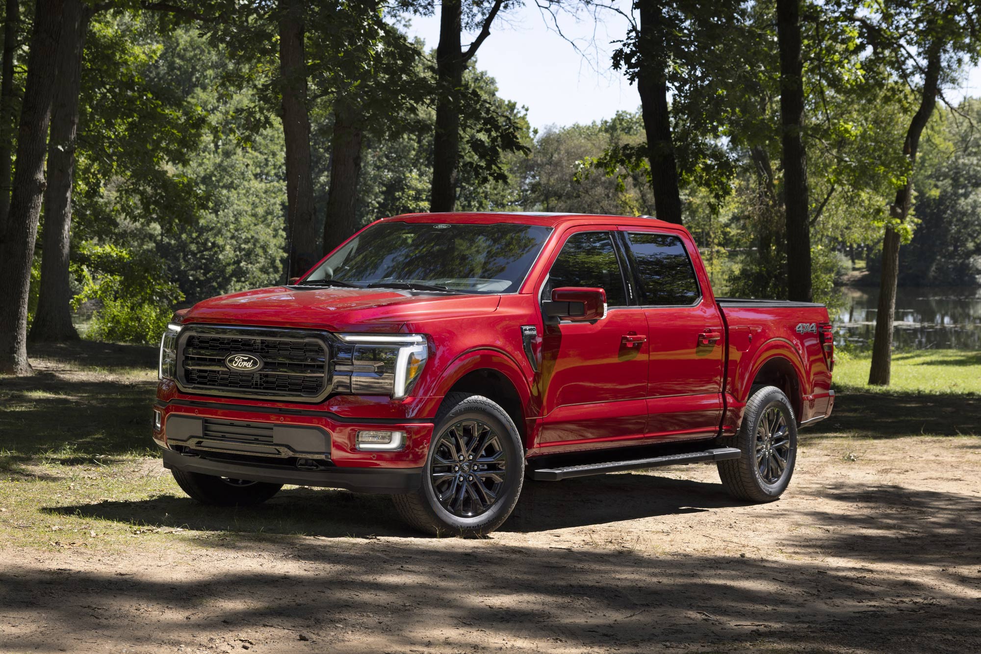 Red 2024 Ford F-150 Lariat parked in the woods