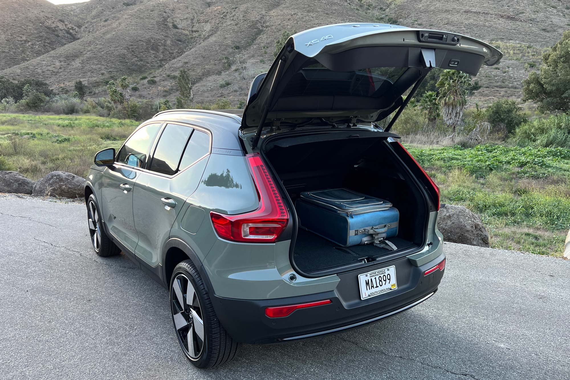 2023 Volvo XC40 Recharge with hatch open and carry-on luggage stored.