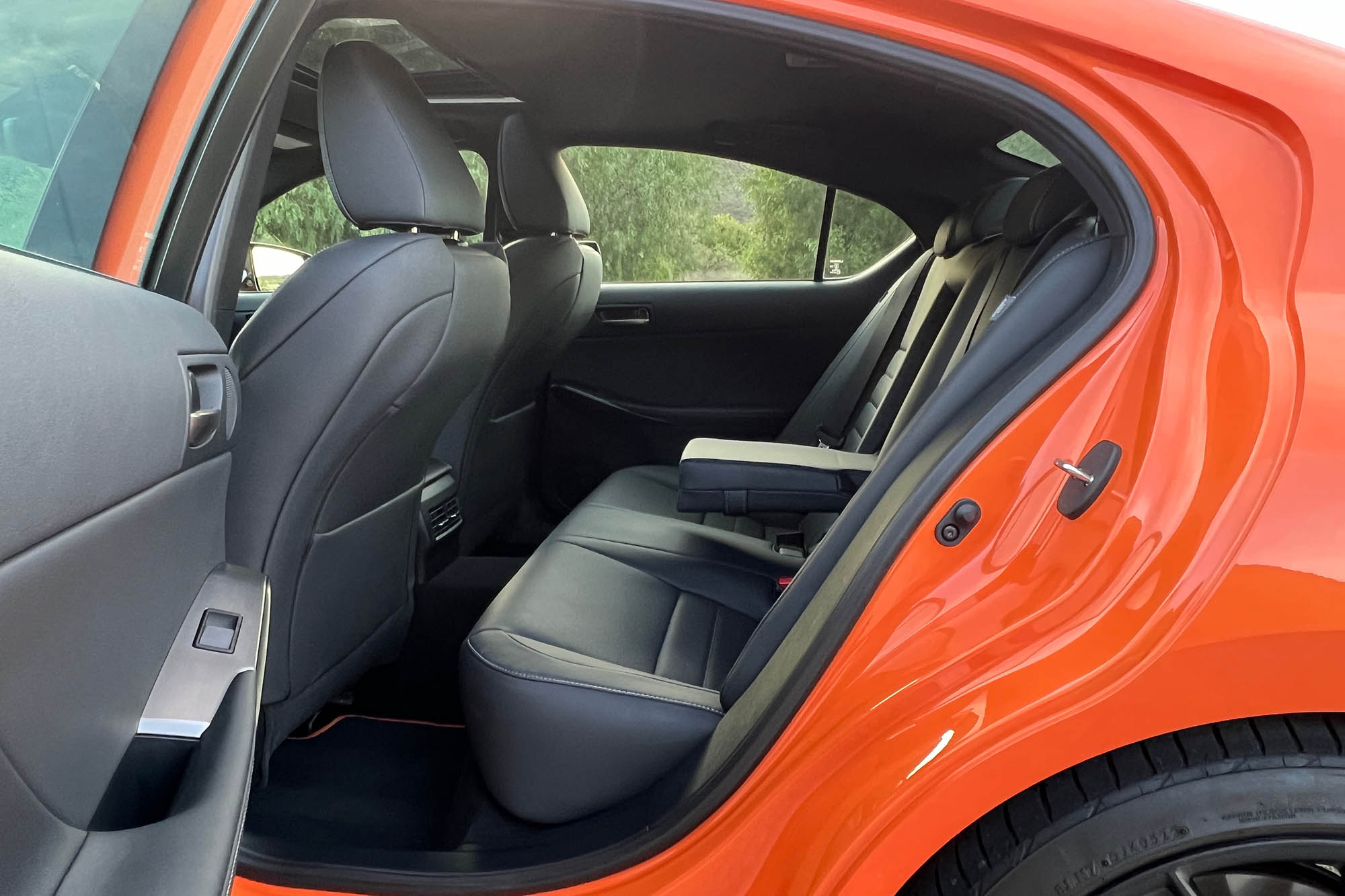 The rear seats of an orange 2023 Lexus IS 500