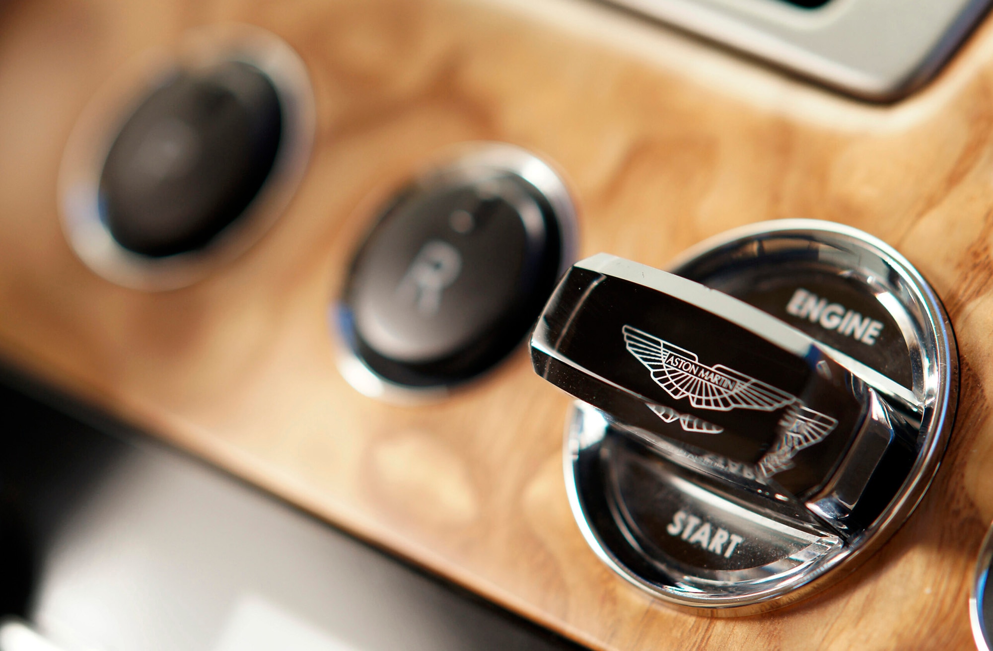 A crystal-topped key fob sticking out on an Aston Martin Rapide dashboard