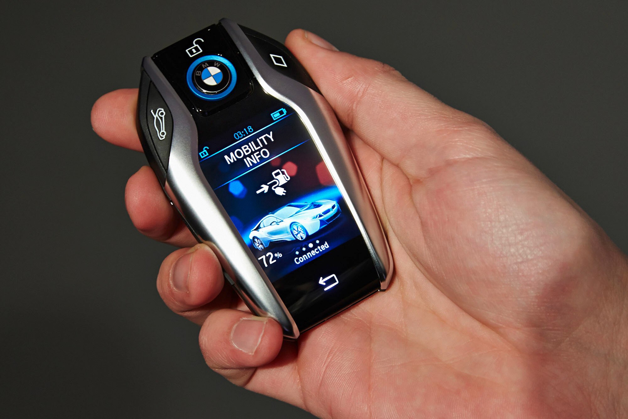 A BMW key fob with an LCD screen