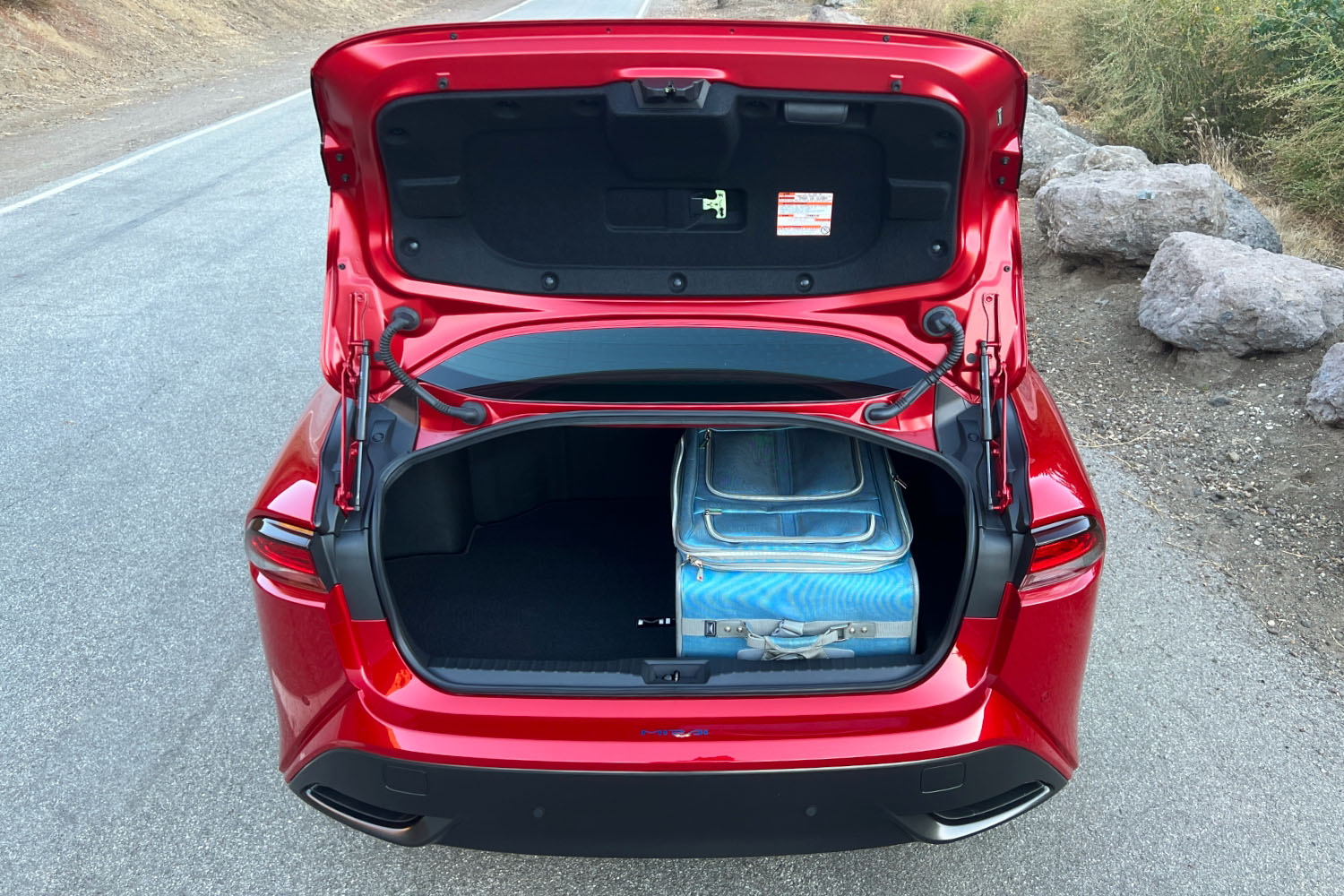Cargo area of the 2023 Toyota Mirai with a stowed suitcase
