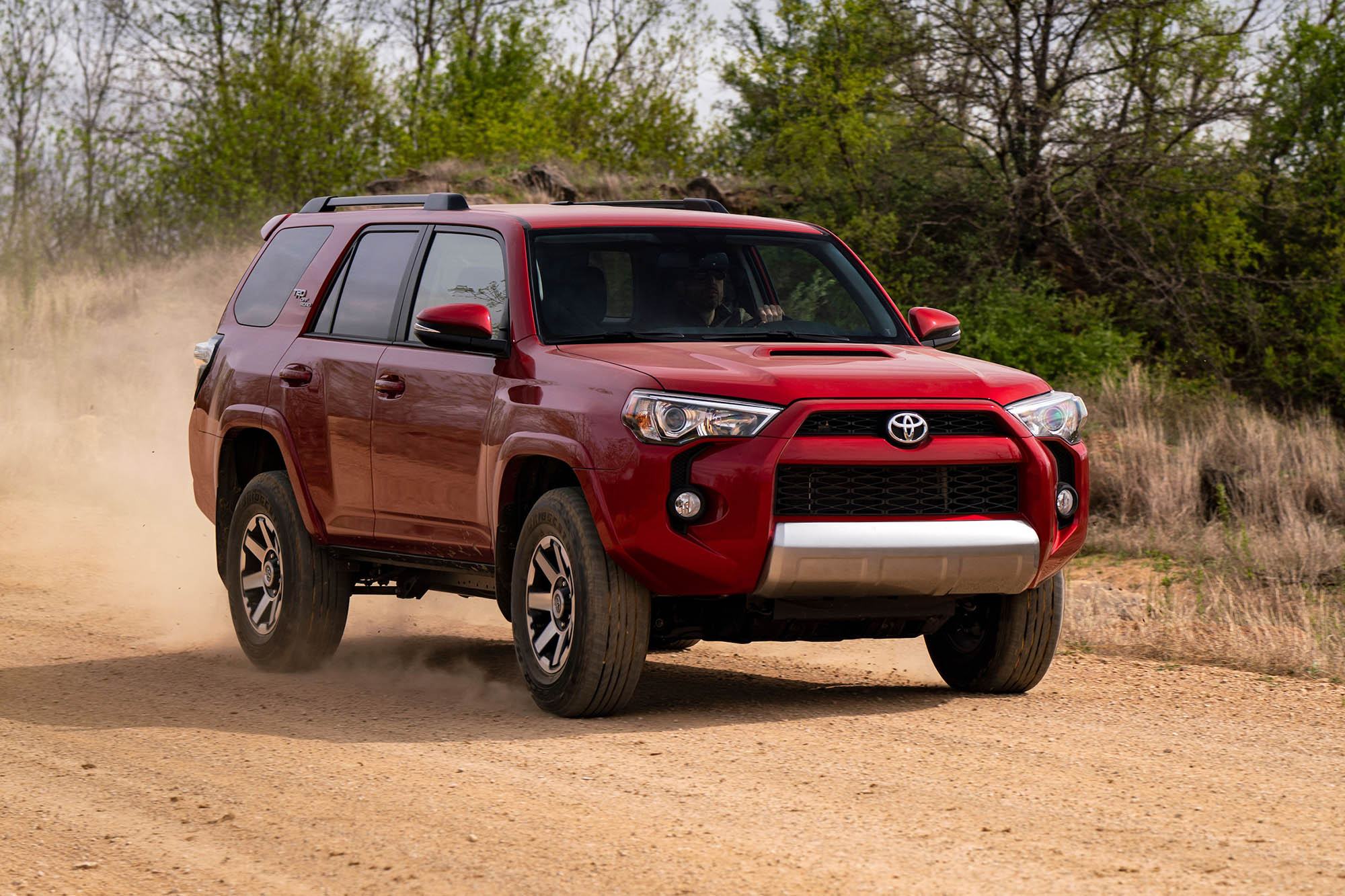 Red 2019 Toyota 4Runner driving on a dirt road