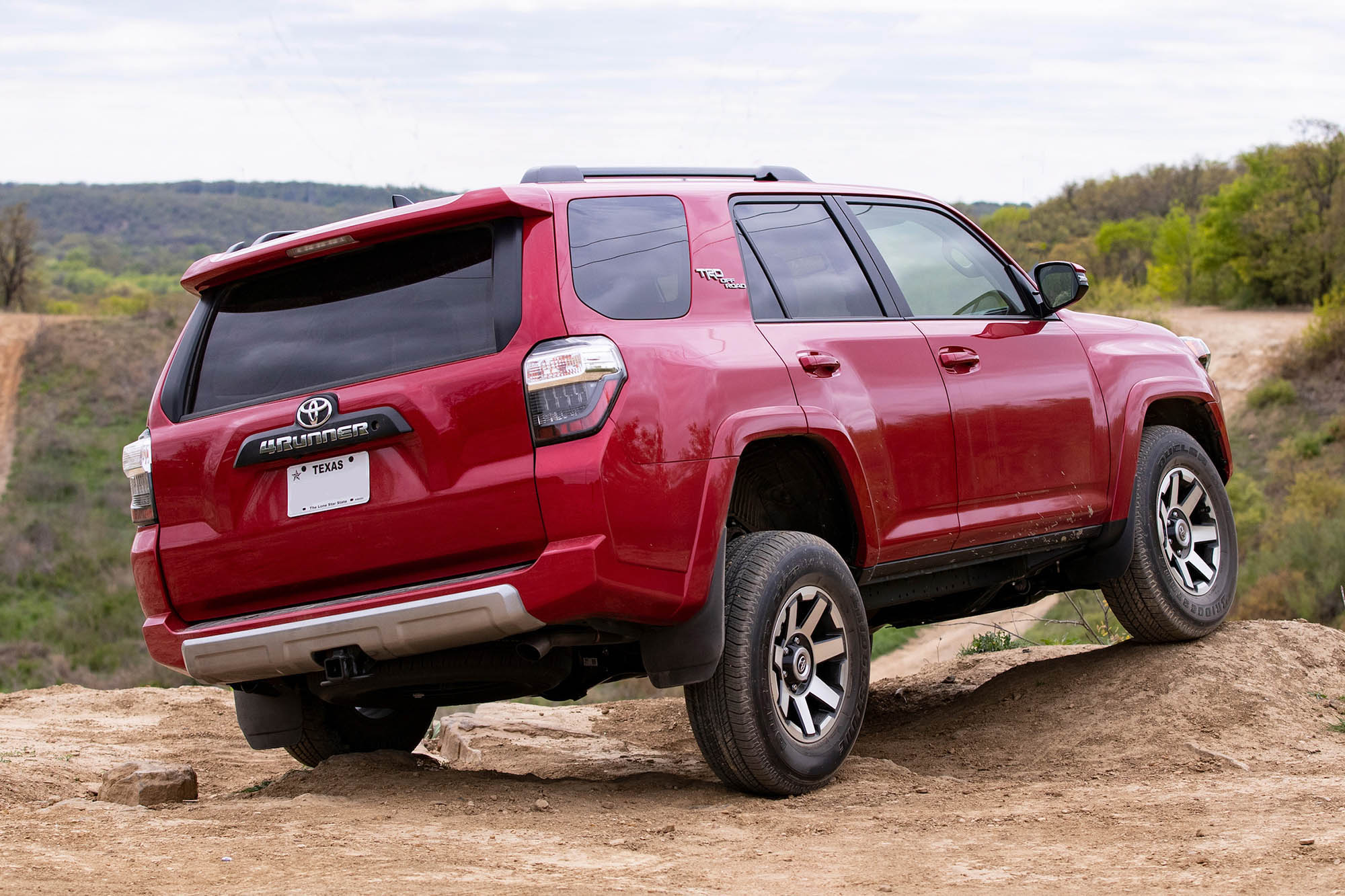 Right rear view of a red Toyota 4Runner showing suspension articulation
