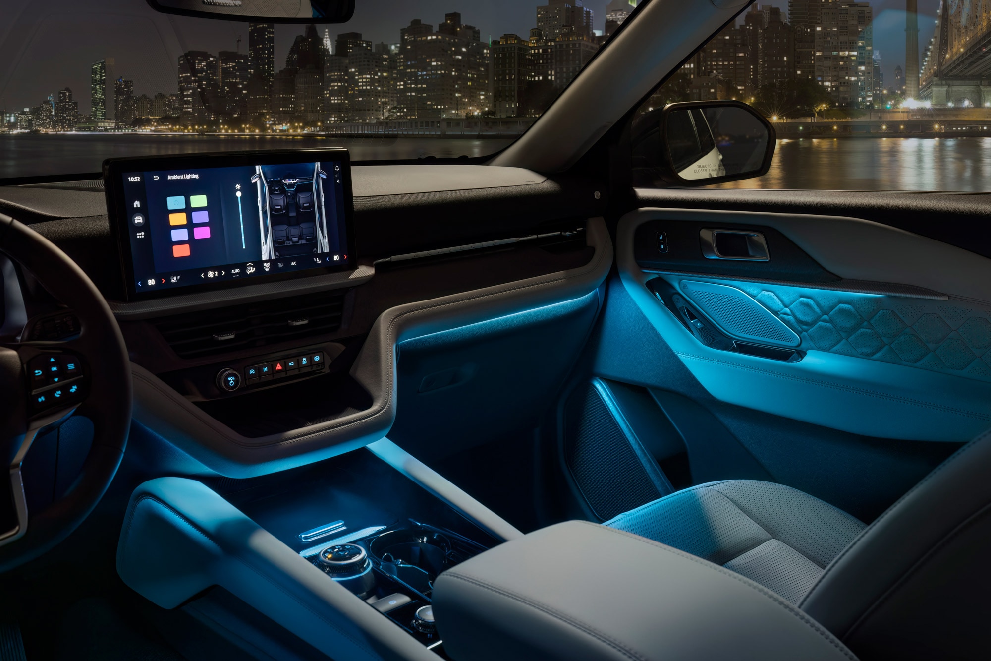 2025 Ford Explorer interior at night with blue ambient lights illuminated.