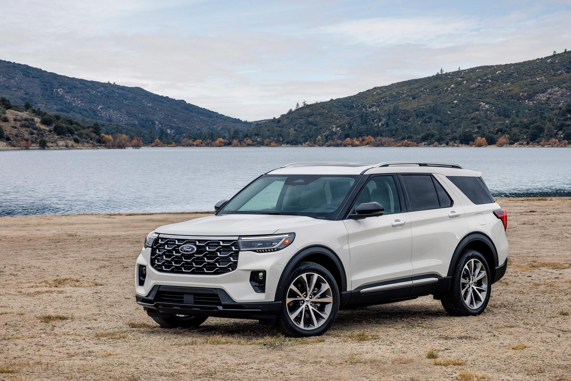 2025 Ford Explorer parked on a beach by a body of water.