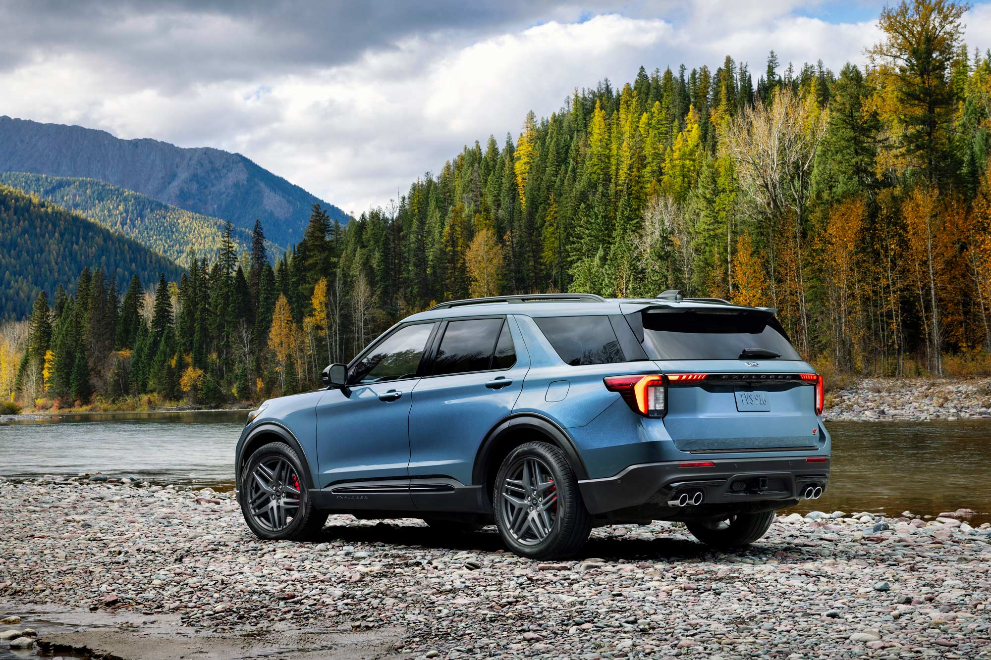 2025 Ford Explorer parked on rocks near a river.