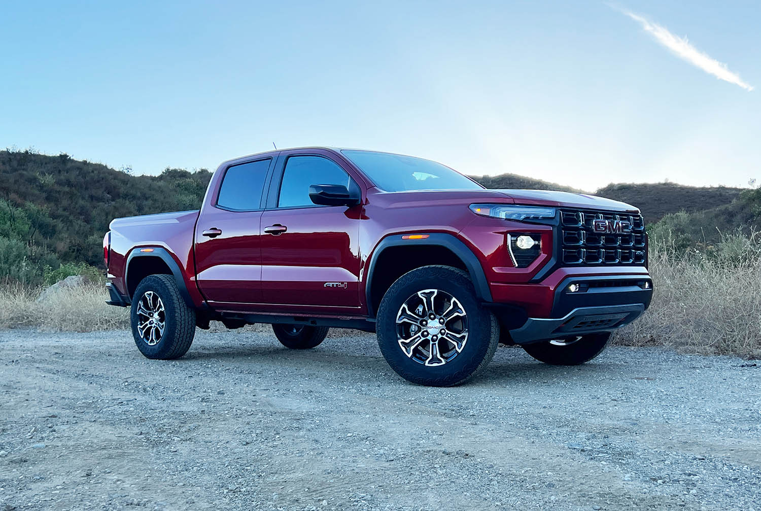 Right front quarter view of a 2023 GMC Canyon on a dirt road