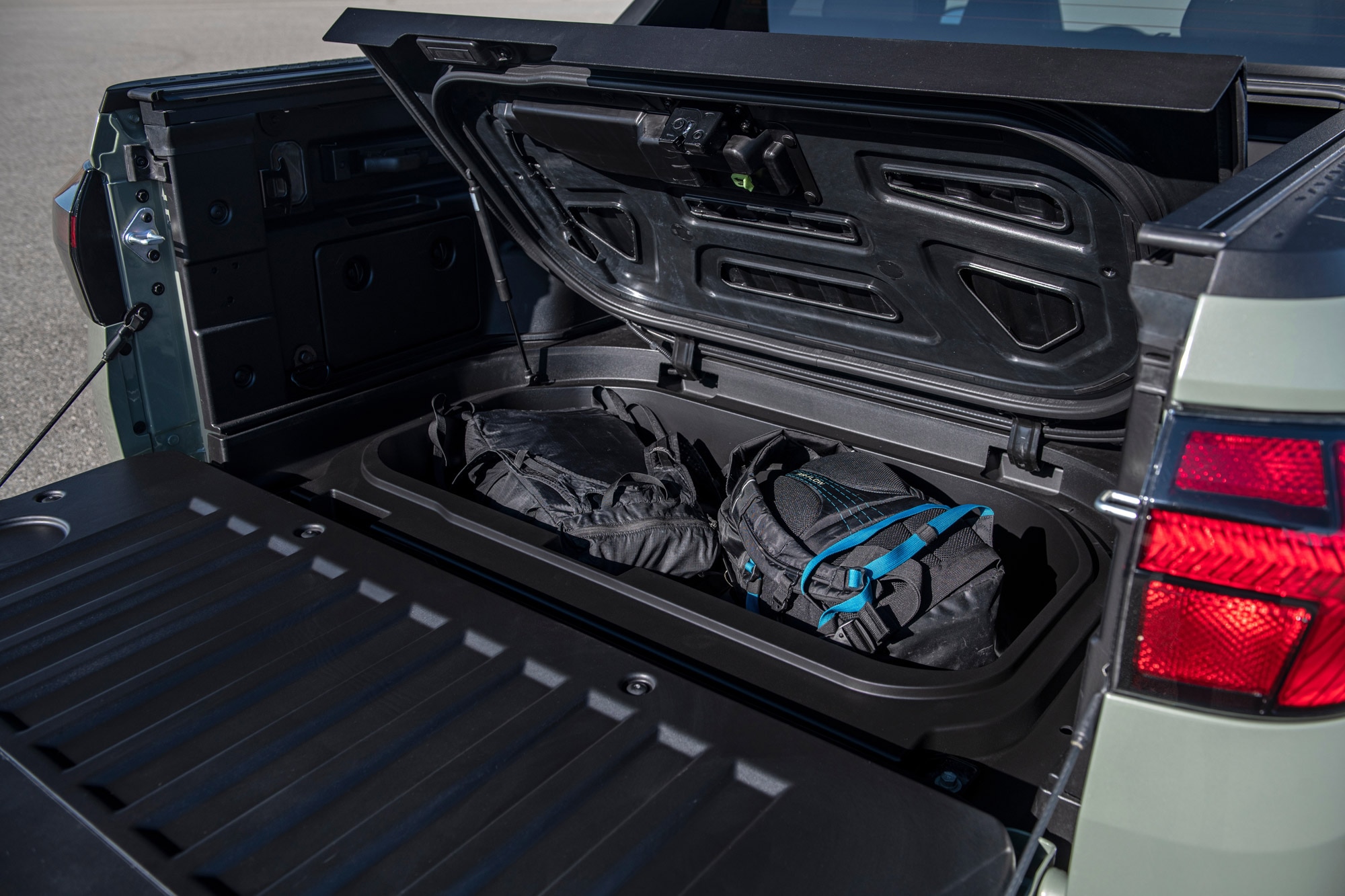 2024 Hyundai Santa Cruz bed storage compartment with lid open.
